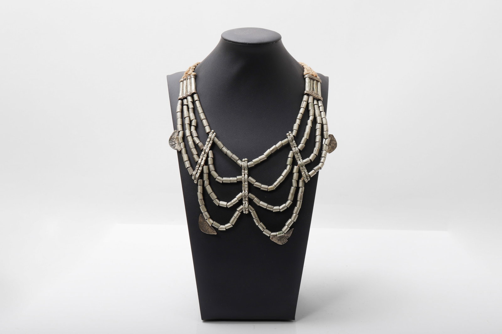 Ethiopian Multi-Strand Silver Bead Necklace: Ethiopia, 19th - early 20th Century. Ethiopian multi-strand silver bead necklace. Composed of multiple strands of tubular silver beads arranged in graduated festoons, joined at the shoulders by