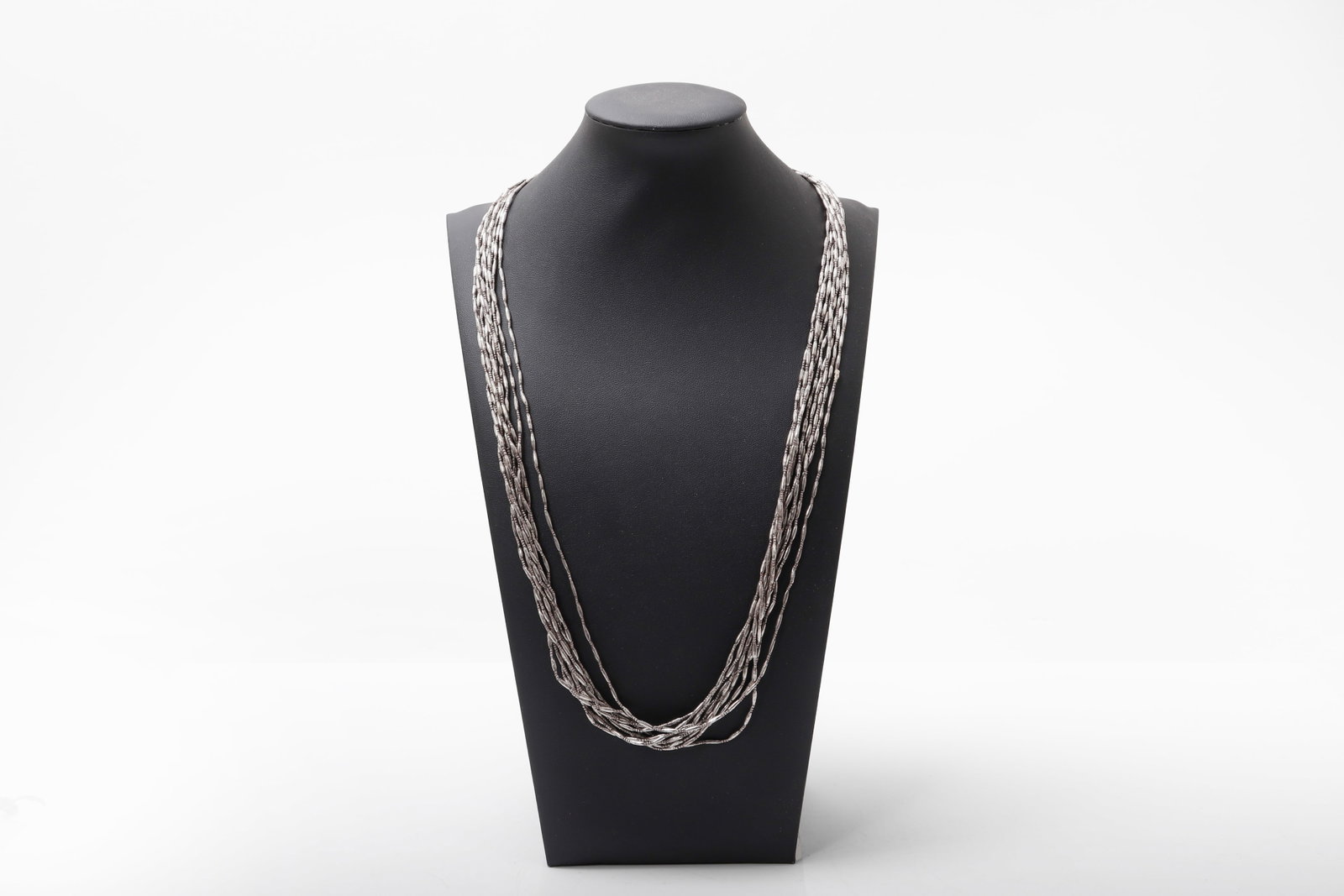 Thai Multi-Strand Silver Bead Necklace: Thai early 20th century Composed of numerous finely worked strands of elongated, tubular silver beads, each individually formed and strung to create a fluid, cascading arrangement. The strands gather