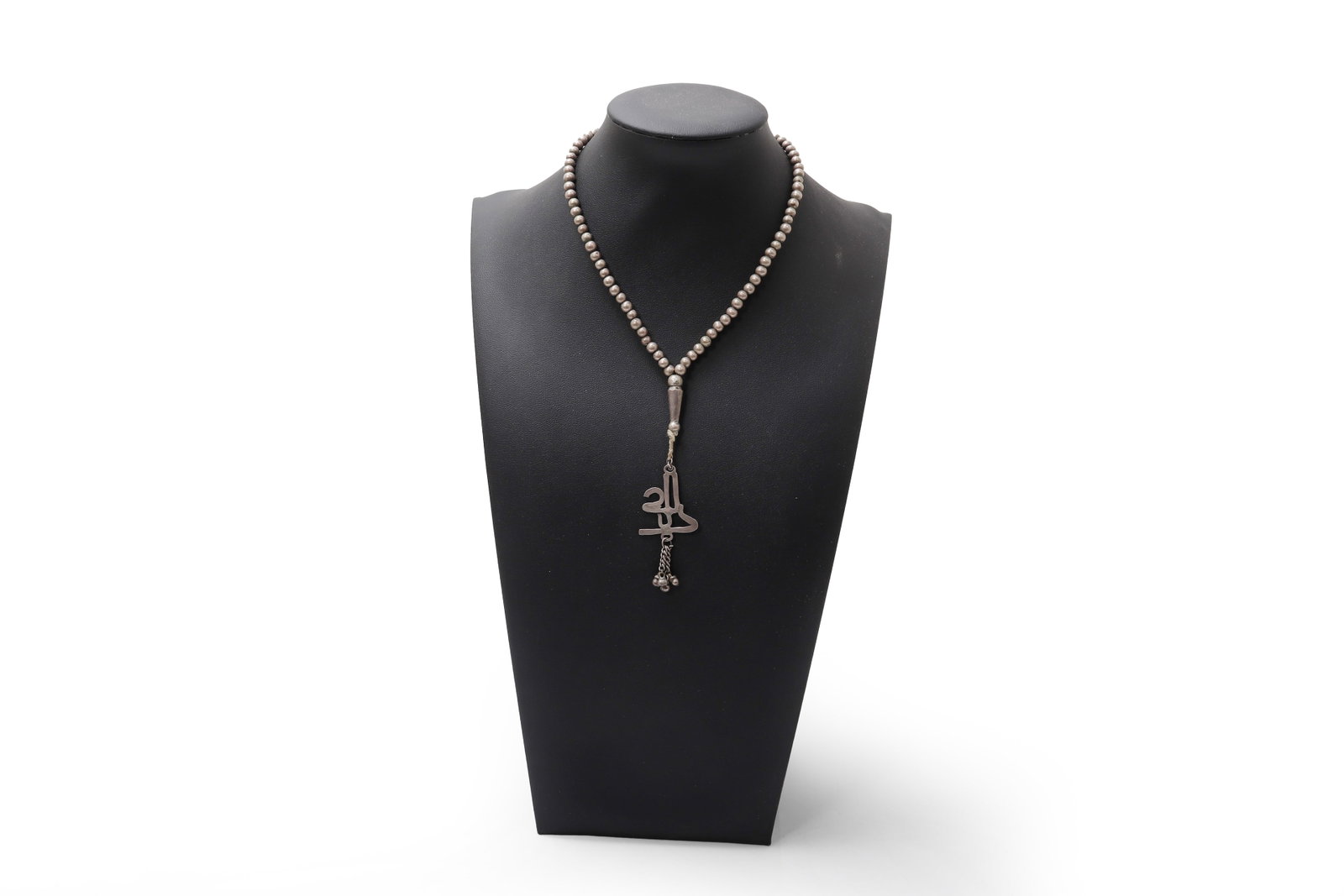Silver Bead Necklace with Amulet Pendant, Pakistan: Pakistan, 19th to early 20th century. Pakistan silver prayer bead necklace centered by an amuletic pendant suspended beneath a tapered silver element, the pendant formed in an openwork calligraphic
