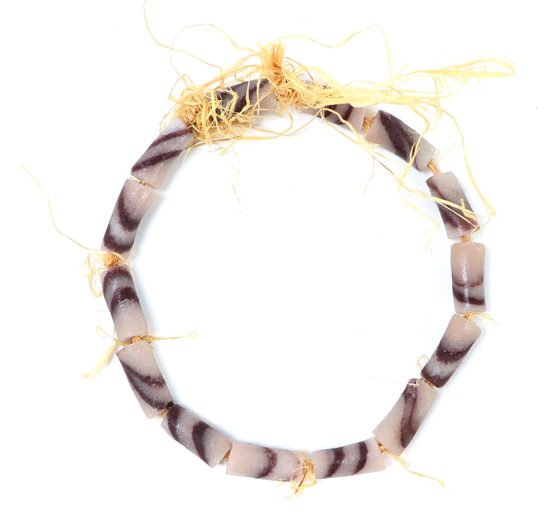 Gorgeous Hand Crafted African Trade Beads: Beautiful hand crafted African trade beads in a beautiful snow white and dark purple coloring throughout in zebra stripes. Fourteen beads in total stranded together on braided rattan. Size 10 1/2" L,
