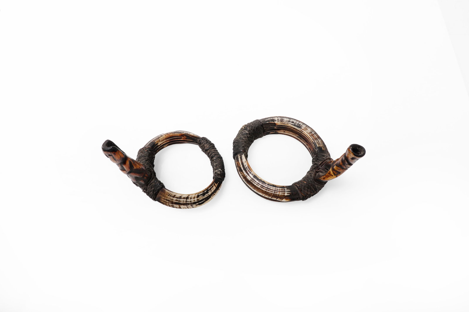 Pair of Tankil Armbands, Bontoc Peoples 19th C.: Philippines, Bontoc Peoples, Pair of Rare Tankil Warriors Armbands 19th century. Pair of circular armbands formed from boar tusks, each circular form and fitted with projecting Nara wood carved Bulul
