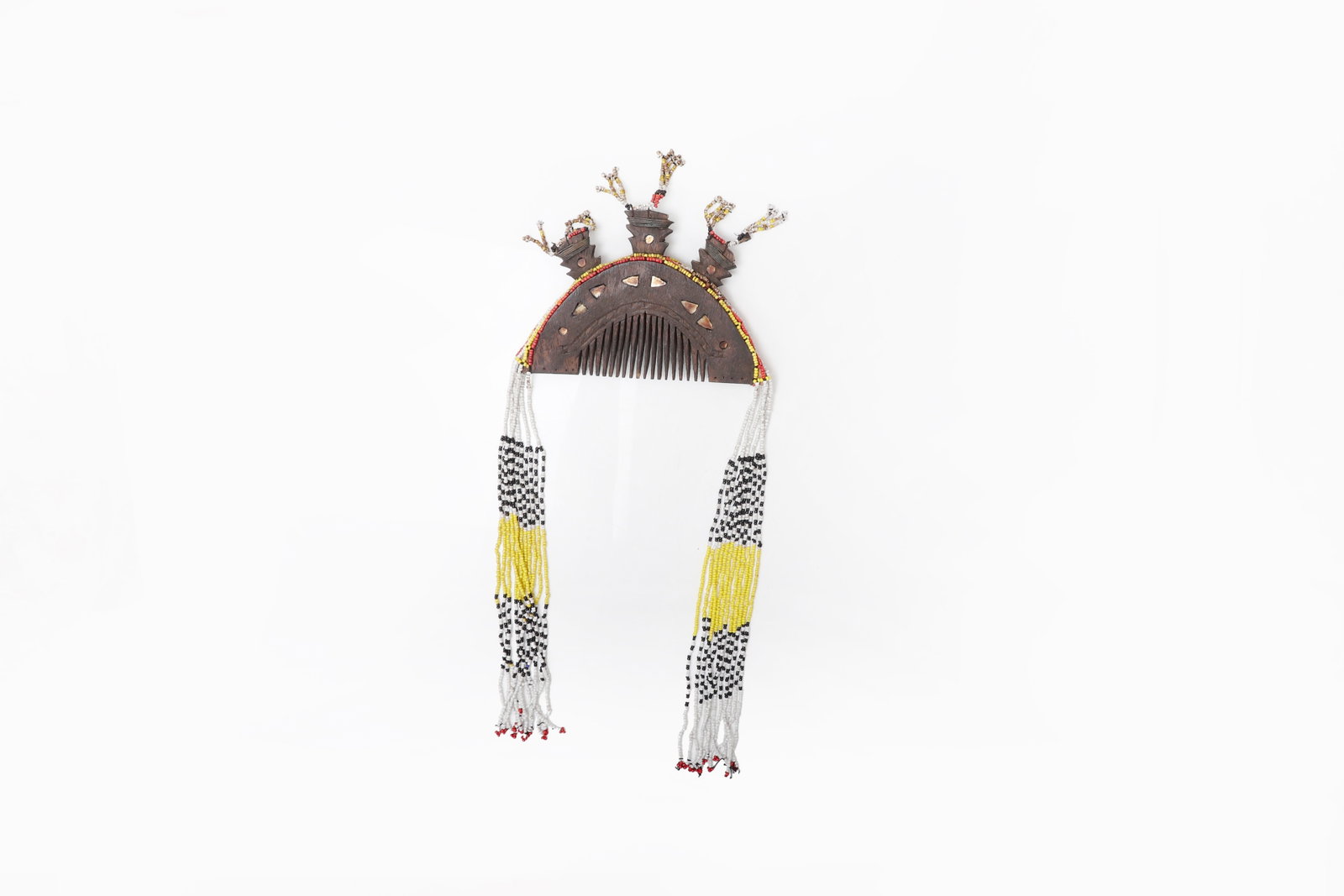 Philippine Mindanao Beaded Comb: Philippines, Mindanao, 19th to early 20th century. Carved wooden comb with openwork crest, surmounted by three projecting finials and ornamented with suspended strands of glass beads in white,