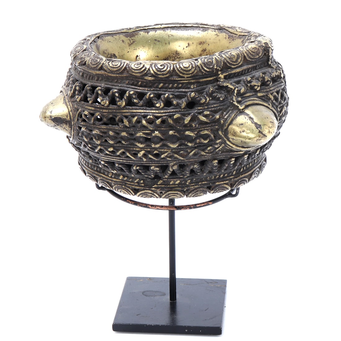 Cameroon Bronze Currency Bracelet: Cameroon, 19th century. A large cast bronze or copper-alloy currency bracelet of substantial weight, the broad circular form decorated with raised spiral motifs around the rim, pierced openwork