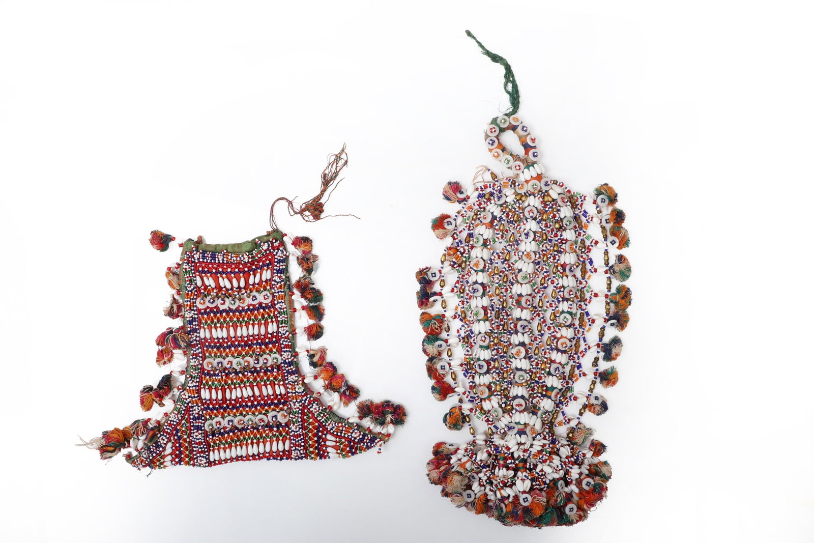 Pair of Indian Beaded & Shell Adornments: India 20th century Pair of Indian Beaded & Shell Adornments. A colorful pair of textile ornaments or small pouch-form adornments, each densely worked with polychrome seed beads, rows of cowrie shells,