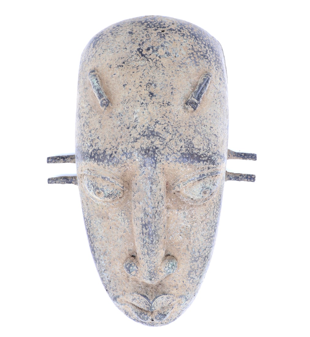 African Bronze Mask, Lobi-Style: Large African bronze mask, probably Lobi peoples Burkina Faso, possibly 19th century or later. Stamped with date (1828 or 1822) to the interior. Elongated nose, excentric scarification tattoos to the