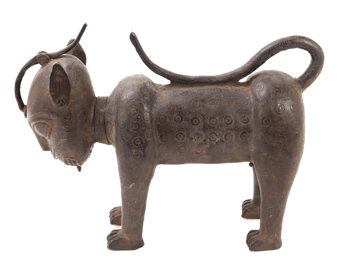 Benin-Style Bronze Leopard Aquamanile: Nigeria / West Africa, probably 20th century. Lost-wax cast bronze or brass vessel in the form of a standing leopard, the body decorated throughout with incised circular spot motifs over a finely