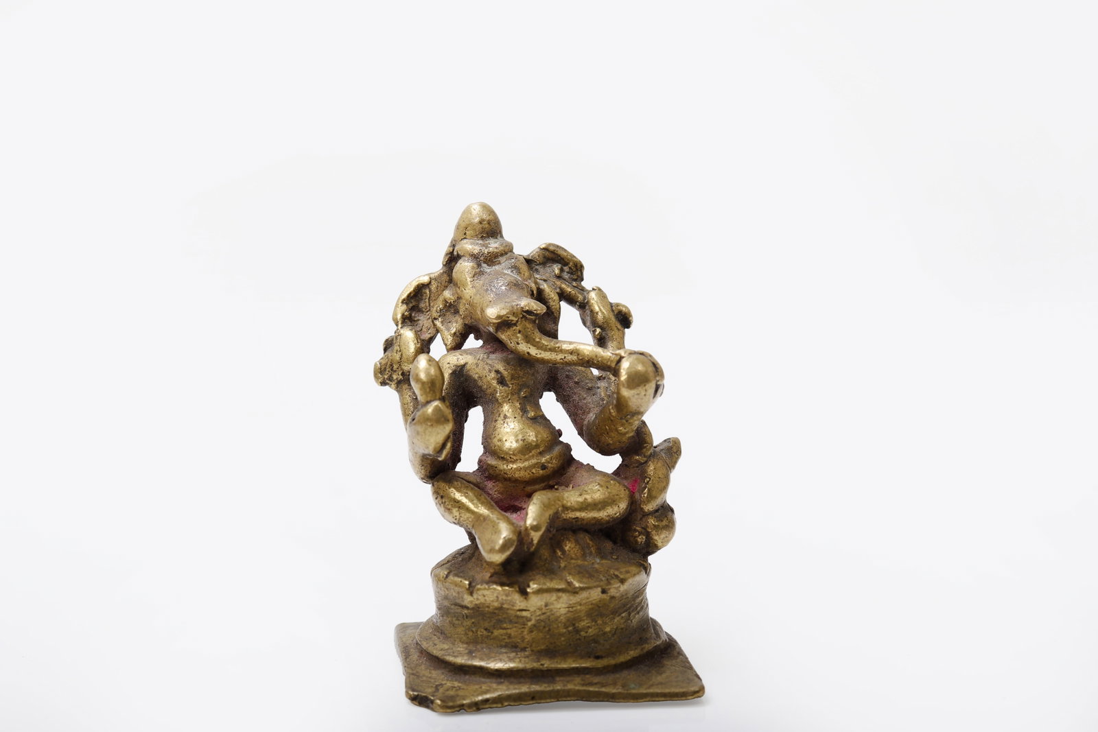 Miniature Indian Bronze of Ganesh, Circa 1800s: Antique votive sculpture of Lord Ganesha, dating to approximately the 19th century. This piece is likely a pilgrimage figure from Maharashtra, India, and exhibits the beautiful, soft wear typical of
