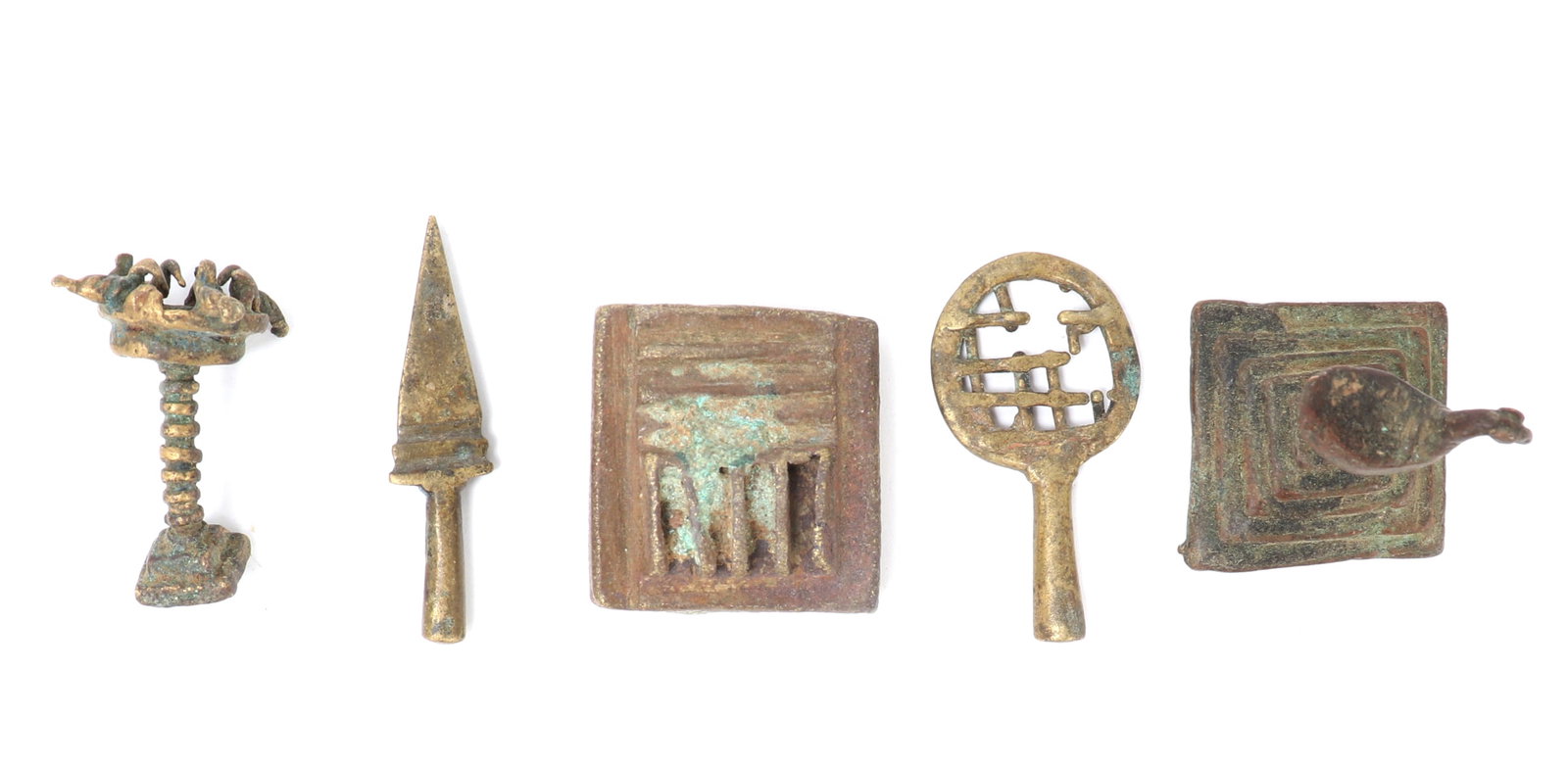 Akan Gold Dust Weight Collection: A charming assemblage of five cast-bronze or brass gold dust weights from the Asante (Ashanti) peoples of Ghana, each in a distinct talismanic form. The group includes miniature representations of a