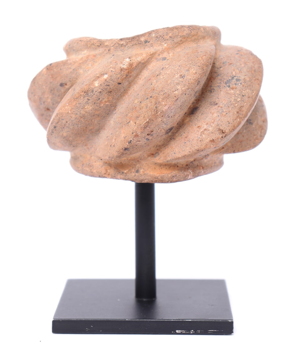 Abstract Chavin Mace Head, 900-200 BCE: Pre-Columbian, Chavin culture 900-200 BCE. Ceremonial abstract mace head carved from brown stone with a series of heavily spiraled edges. Each deeply carved with 7 disc like flanges around a central