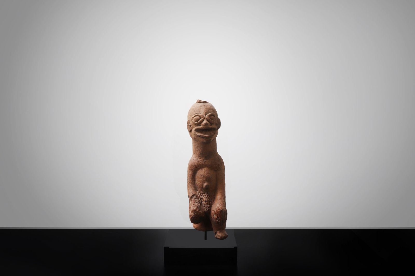 West African Terracotta Standing Figure, Bura/Nok Style: West Africa, possibly Niger or Nigeria, in the style of Bura or Nok terracotta figural traditions possibly 500BCE-200CE A slender terracotta male figure of highly stylized form, standing with