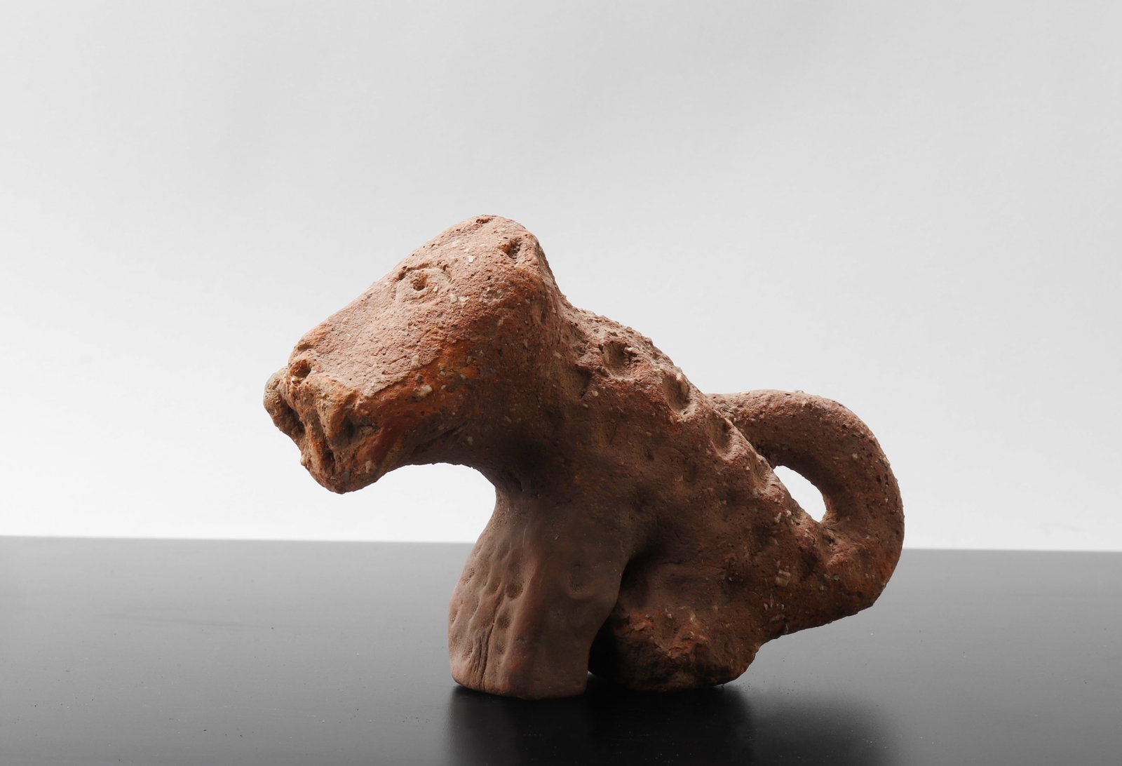 Rare Ancient Terracotta Animal Effigy: West Africa, Possibly 500 BE to 300 CE. Terracotta Zoomorphic figure. A highly evocative terracotta zoomorphic sculpture, the form abstractly rendered possibly equine, hyena, or antelope, with a