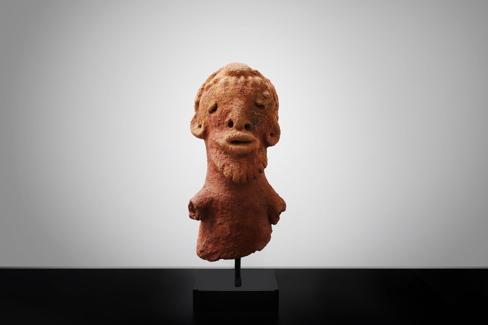 African Terracotta Torse, Bura-Style: West Africa, Niger, probably Bura in the style of the 300CE - 1000CE. Male torse with beard mounted on custom stand. 14"H 6"W Ex-Los Angeles Gallery