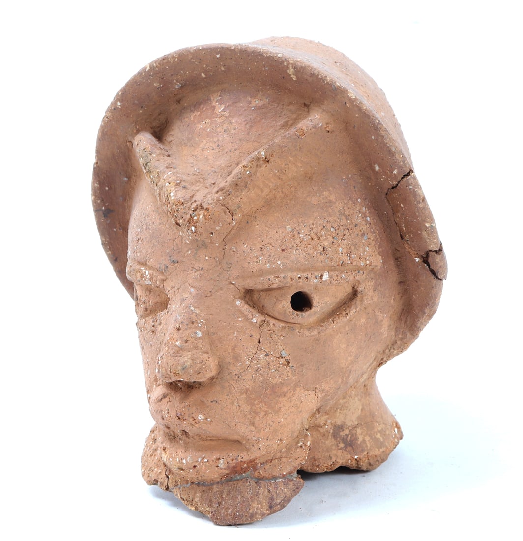 Terracotta Nok Head w/ Hat, 1500BCE - 500CE: West Africa, Nok culture 1500BCE - 500CE. Large Nok figure head wearing a large hat. Connected brow line and pierced eyes. Size 6 1/4" H, Weight 3.63 lb. Ex-USA Collection. Family collection of an est