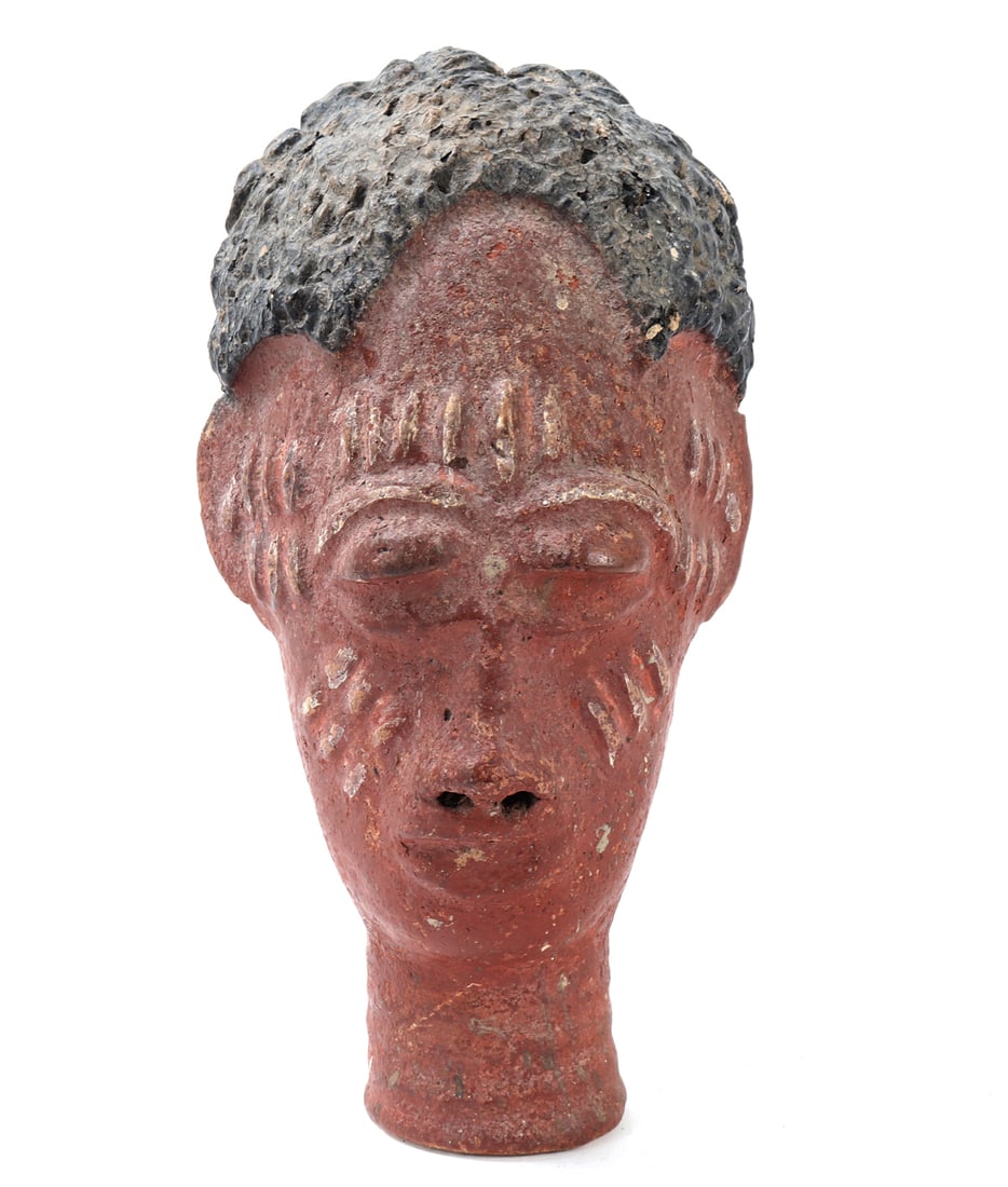 African Painted Terracotta Head: West Africa, 20th century. A painted terracotta head of elongated form, modeled with a narrow cylindrical neck, rounded facial plane, pierced nostrils, full lips, and heavy lidded eyes beneath arched