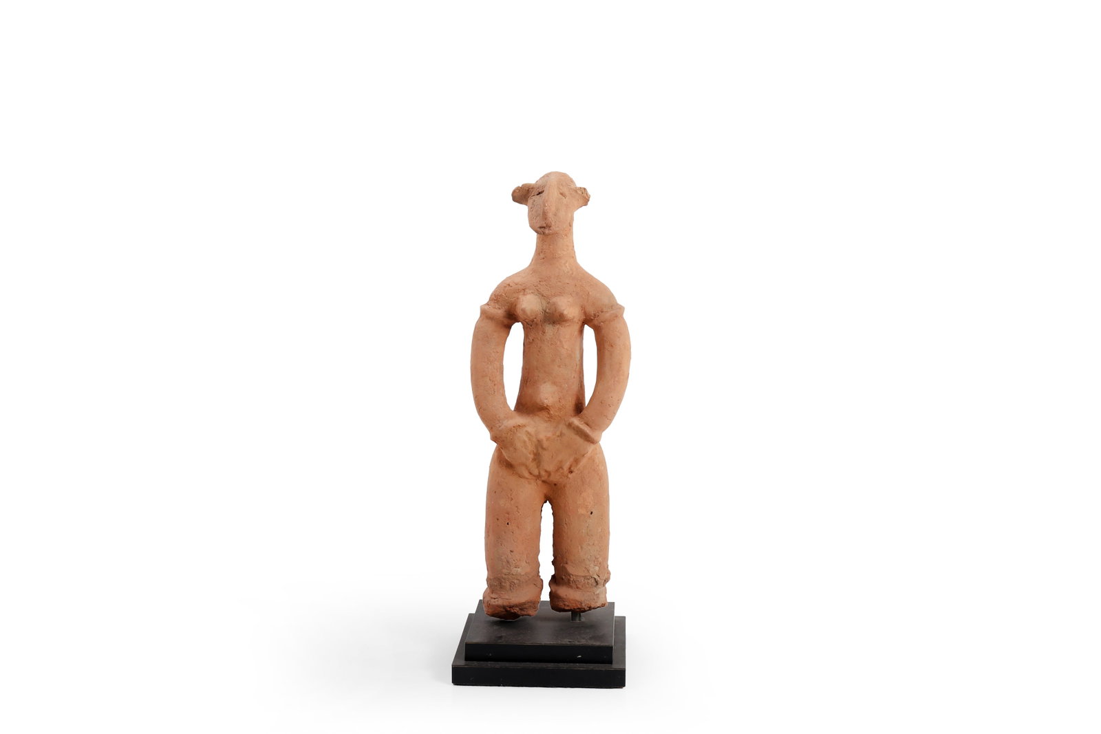 African Terracotta Female Figure: Probably Africa or the Near East, possibly 12th - 16th century. Terracotta standing female figure of highly stylized form, with elongated neck, simplified facial features, rounded breasts, and arms