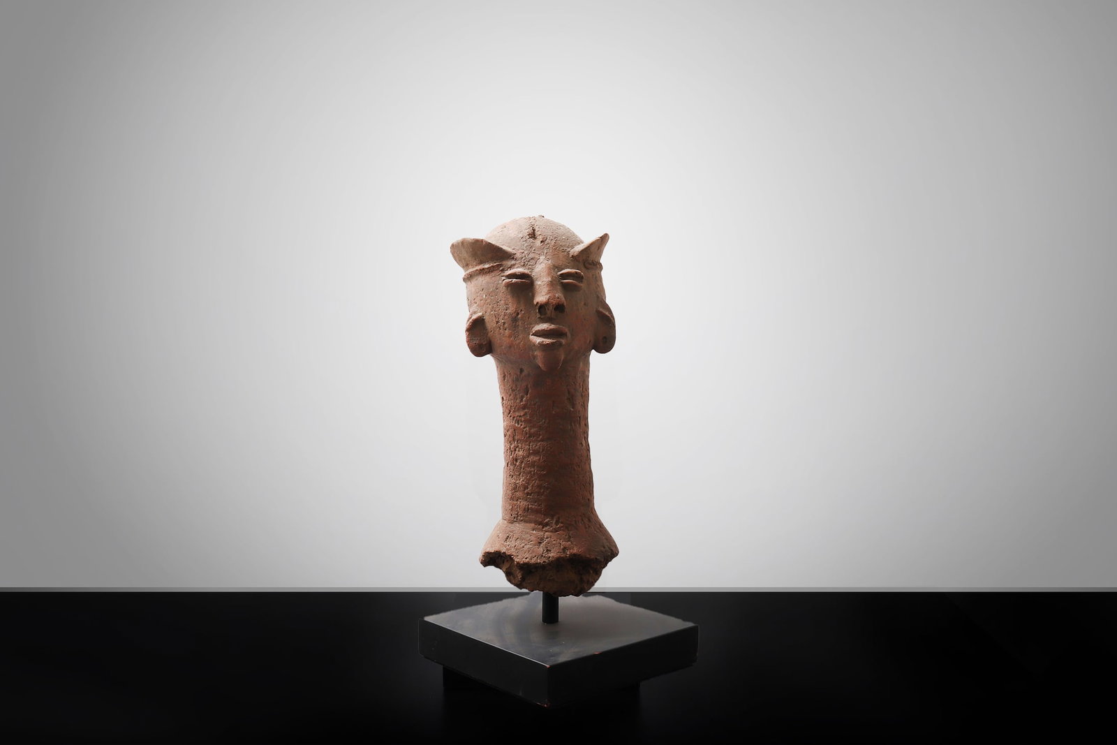 West African Terracotta Head with Coffee-Bean Eyes: West Africa, possibly Niger River Valley / Sahel region, Bura, Koma, or related terracotta tradition, probably medieval period or later. Terracotta head modeled with an elongated cylindrical neck and