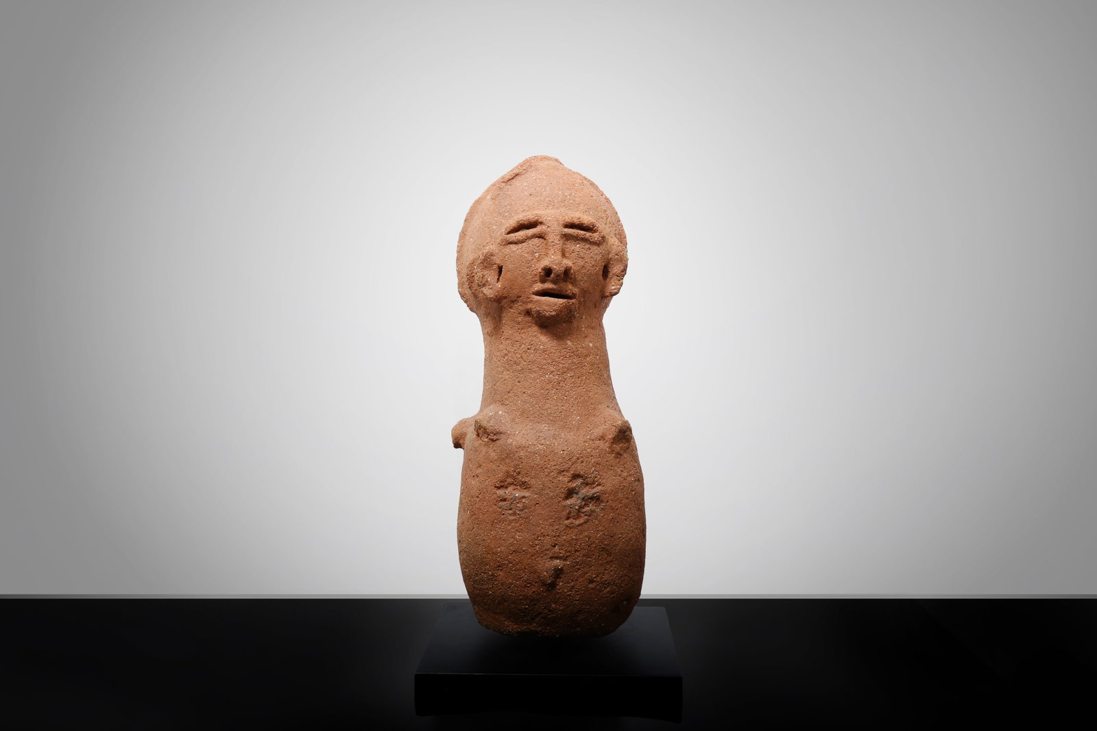 Sokoto Terracotta Figure, 500BCE - 200CE: Nigeria, Sokoto Culture / Northern Nigerian Terracotta Tradition circa 500 BCE - 200 CE A terracotta figure of columnar form, modeled with a rounded lower body and elongated neck supporting a stylized