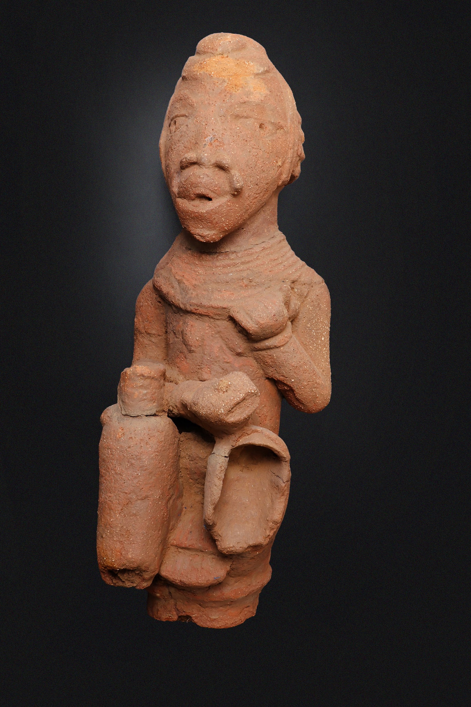 Large (60cm) Nok Terracotta Figure, 500BCE - 200CE: West Africa, probably Nigeria, Nok culture, circa 500 BCE ? 200 CE. A large and expressive terracotta figure, probably Nok, modeled in reddish earthen clay with a rounded head, deeply set almond-shape