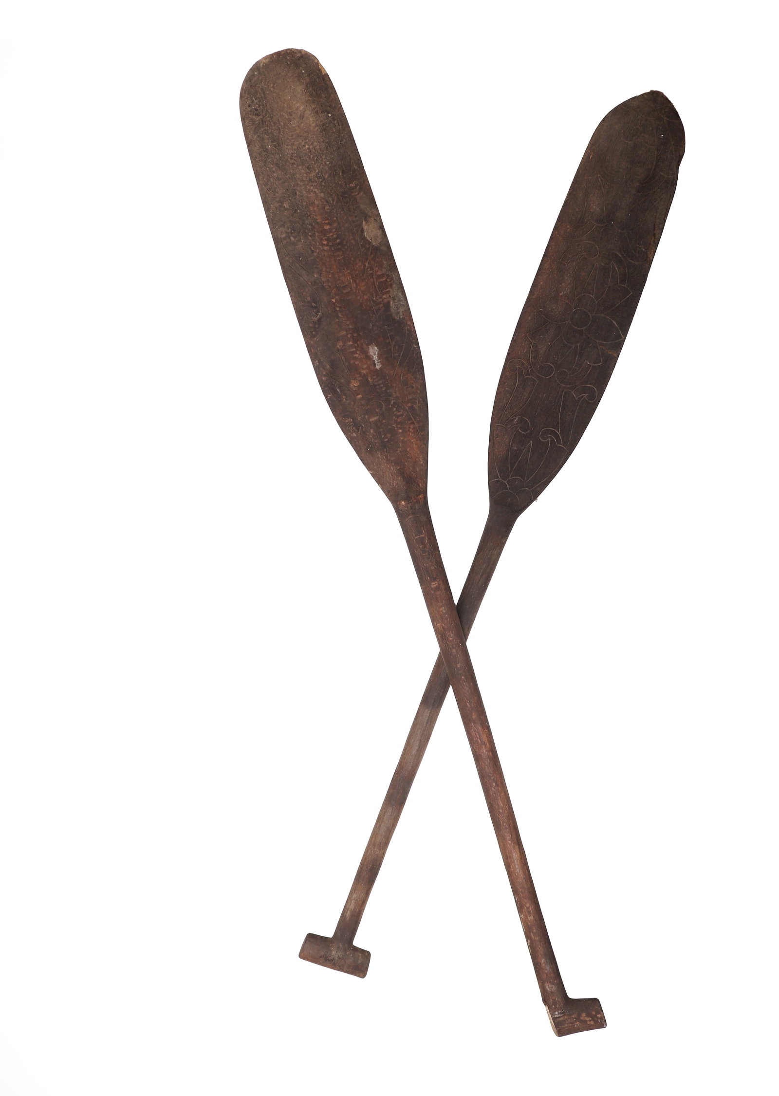 Pair of Large Carved Wooden Oars: Probably Oceania or Southeast Asia, 19th to 20th century. Pair of large wooden oars with long tapering shafts and broad leaf-form blades, each blade further enriched with incised scrolling and floral 