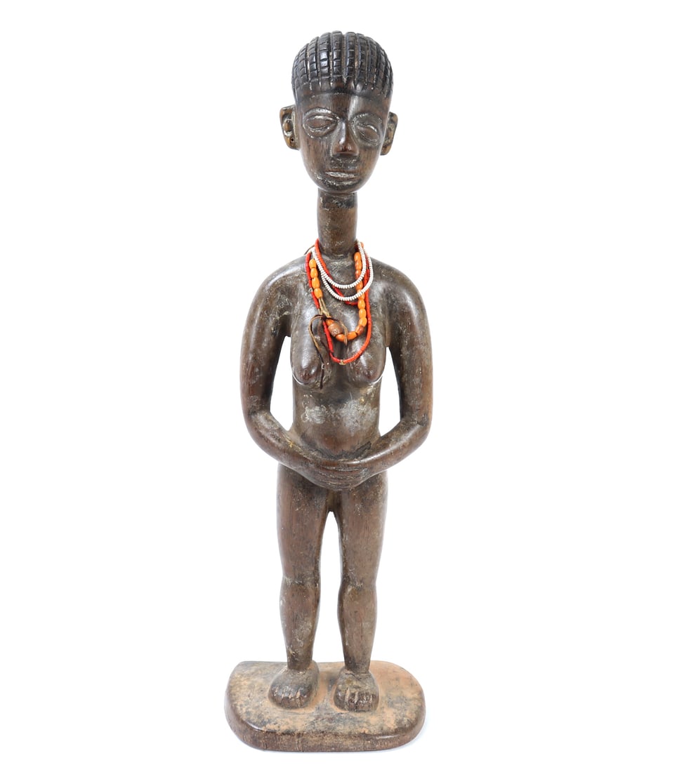 West African Akan / Ashanti Style Standing Female Wood Figure: West Africa, possibly Ghana, Akan / Ashanti style, 20th century. A carved wood standing female figure with elongated neck, stylized facial features, incised coiffure, and hands held across the abdomen