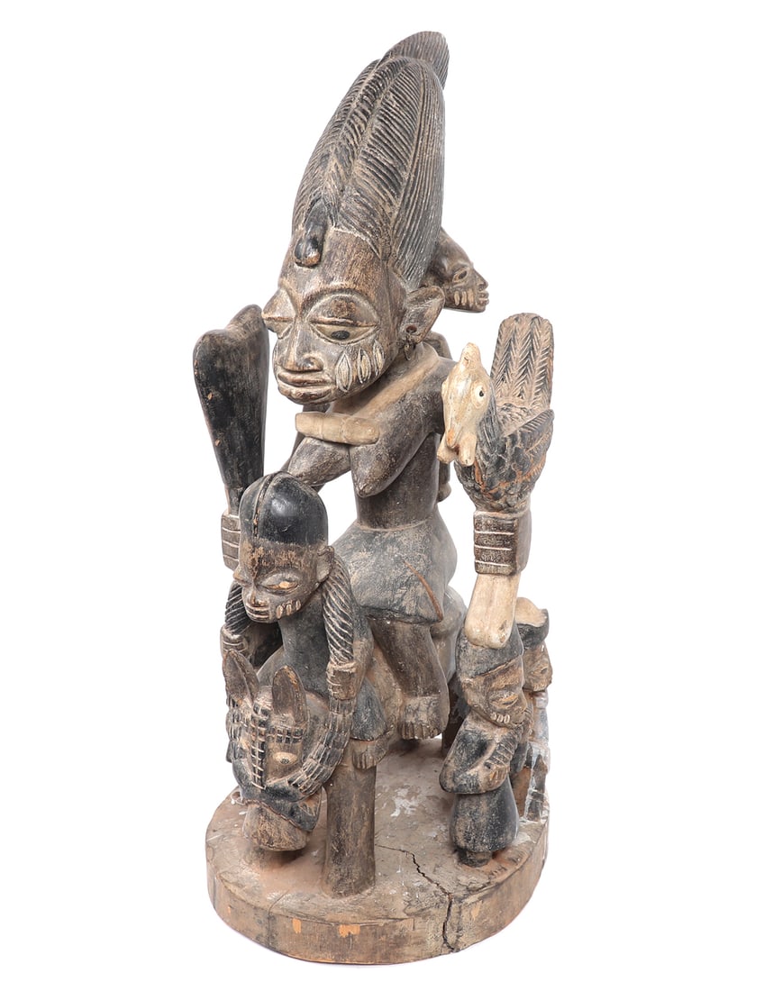 Mother & Child Equestrian Shrine, Yoruba Peoples: West Africa, Nigeria, Yoruba peoples. Large wood carved shrine of a mother and children equestrian scene. The mother in large form holding a rooster in her left hand, ritual mace in her right hand, an