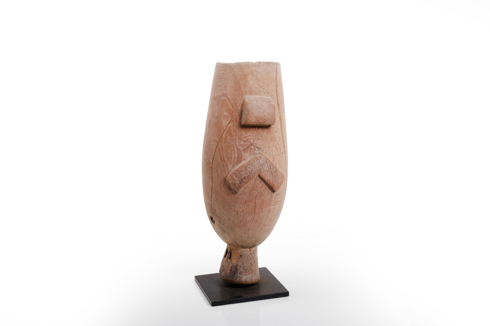 African Carved Wood Zwu Figure: Probably Africa, 20th century or earlier. Carved wood zwu of simplified abstract form, the tapering cylindrical body raised on a short foot and minimally articulated with a projecting nose and angular
