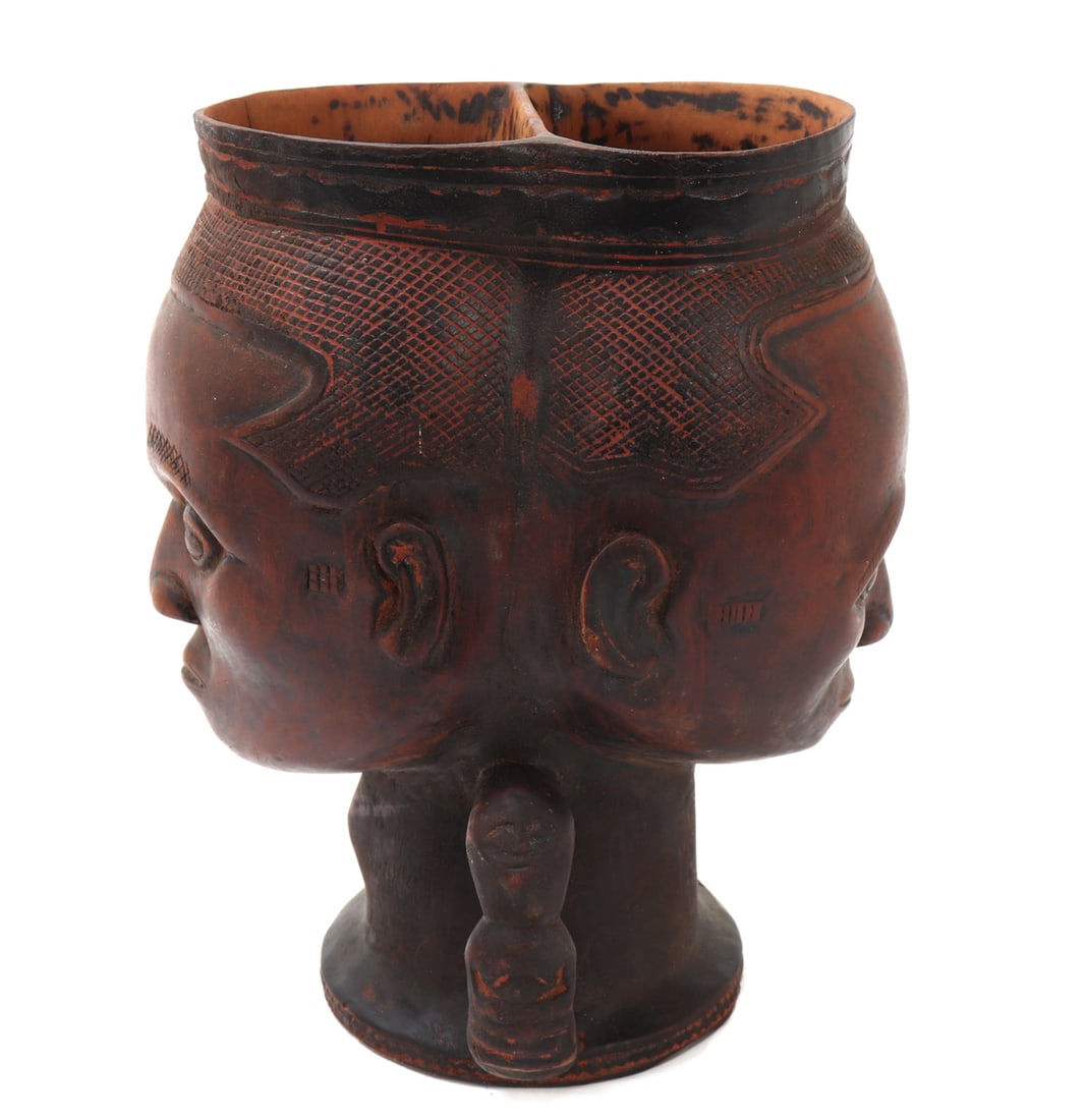 Unique Double Headed Kuba Janus Cup: Wonderful African hand carved wood Kuba Janus cup. Unique in shape and style with two cups in one vessel with faces on each side. Incised throughout emphasizing the hair on each head. Handles are