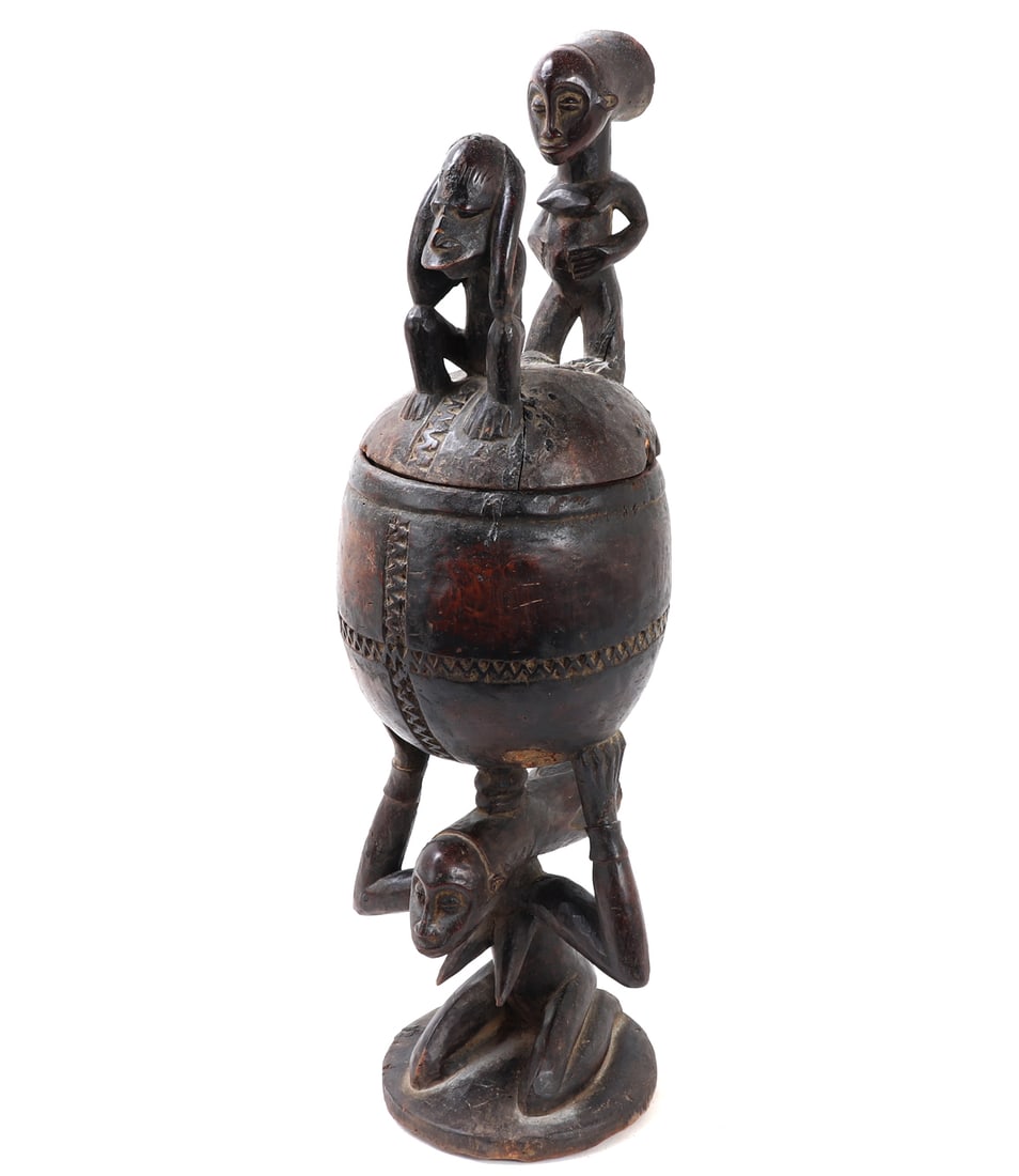 Carved Wood Ritual Cup, Yoruba Peoples: Excellent and well patinated ritual cup vessel with lid probably Yoruba peoples. Carved in a dark brown patinated wood with excellent signs of age and use. The lower base a large female figure with