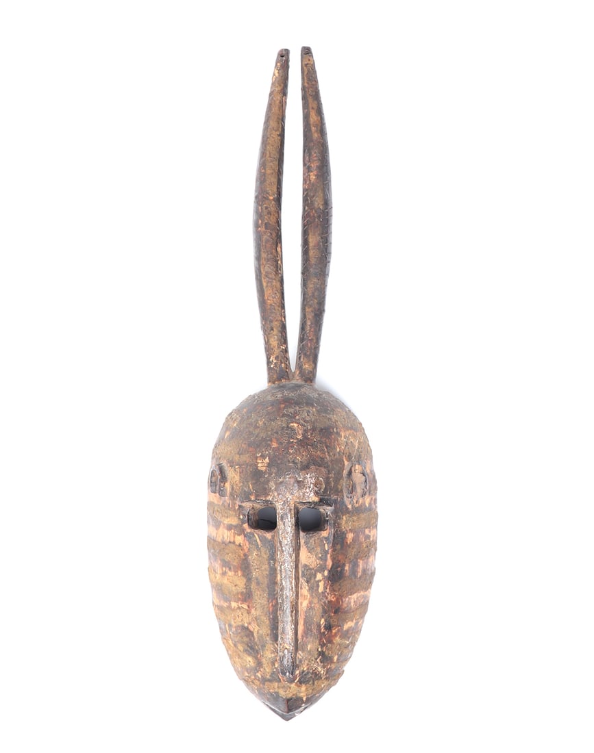 Mossi Horned Mask, Burkina Faso: Burkina Faso, Mossi peoples horned wood carved mask. Heavily coated in pigment consisting of dark green and brown color tones in linear details. Deeply carved with visible wear to surfaces and edges.