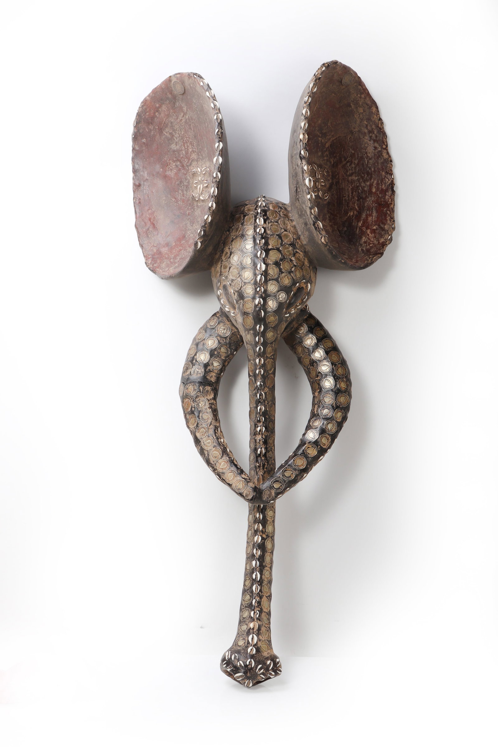 Striking Elephant Headdress Mask, Ghana: West Africa, Ghana Elephant Headdress Mask, 20th century Monumental in scale and striking in presence, this large elephant-form headdress mask is carved from wood and richly adorned with an extensive