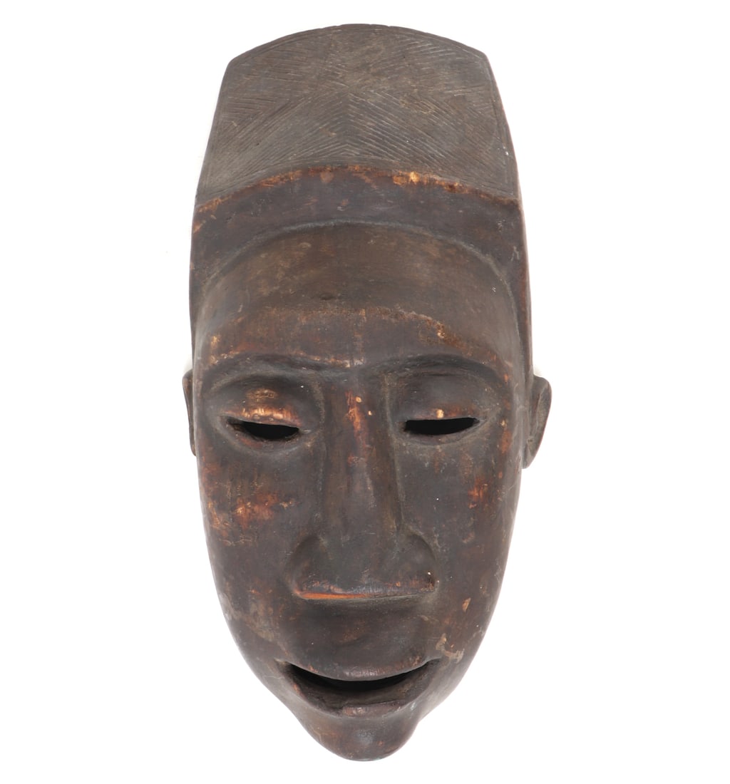 Handsome Hand Carved Bagongo Mask: Nicely carved wood African ceremonial mask. Tall elaborate headdress, almond shaped slit eyes, mouth agape with a triangular protruding nose. Size 13 3/8" L, weight 1 lb. Collected prior to 2008,
