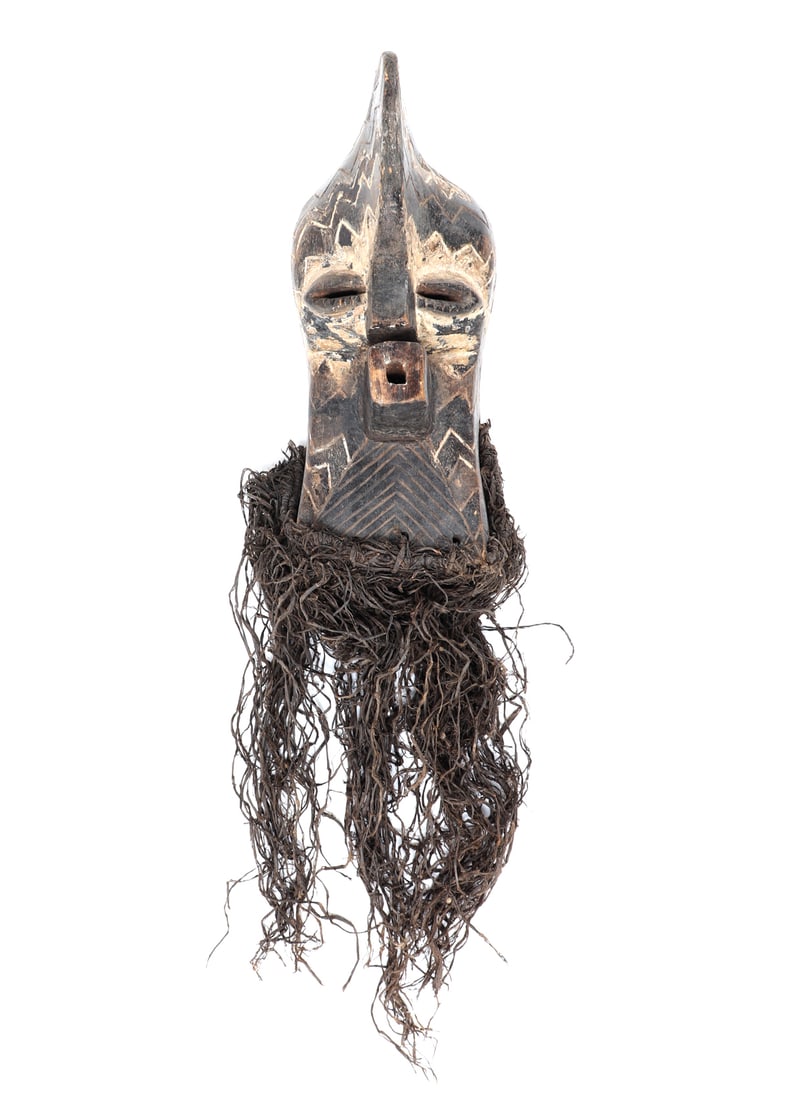 Kifwebe Mask, Songye: Songye peoples, Democratic Republic of the Congo, Carved male head Kifwebe mask with raffia to the base and carving of geometric patterns. Kifwebe masks, used in rituals to maintain order and connect