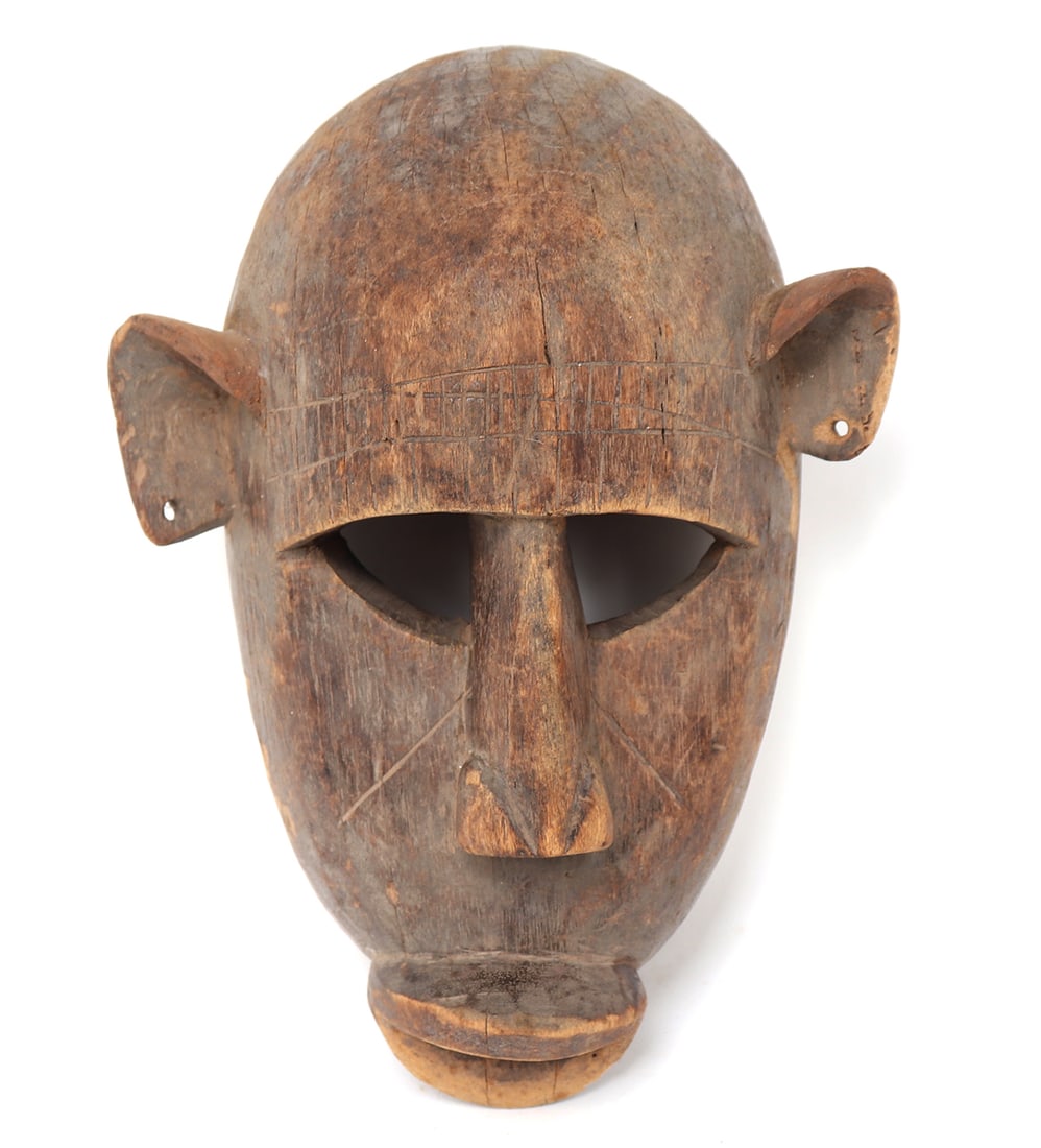 Wood Monkey Mask, Bamana People: West Africa, Mali, Bamana people (also known as Banmana) carved wood monkey mask. Large brow, pierced eyes, pierced ears and protruding lips. Pierced to the border of the reverse with suspension