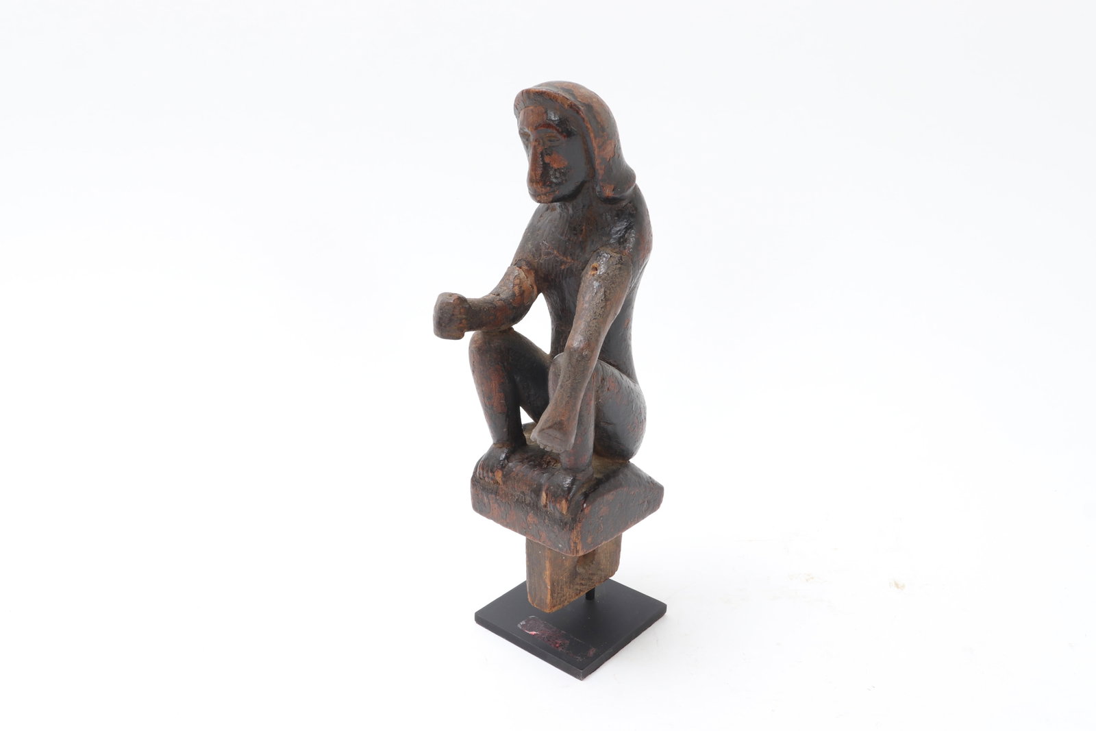 Burmese Oxcart Adornment, Seated Monkey Figure: Burma (Myanmar), probably 19th century or earlier. Carved wooden figure of a seated monkey, shown in crouching pose with bent legs, elongated arms, and a forward-leaning posture, the head framed by a