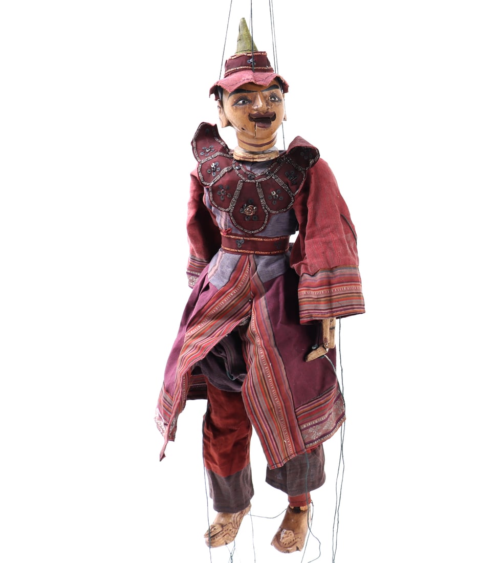 Traditional Burmese Hand-Carved Marionette Puppet: Myanmar (Burma), 20th century. Traditional hand-carved marionette puppet depicting a male courtly figure, dressed in elaborate polychrome costume with layered textiles and painted facial features.