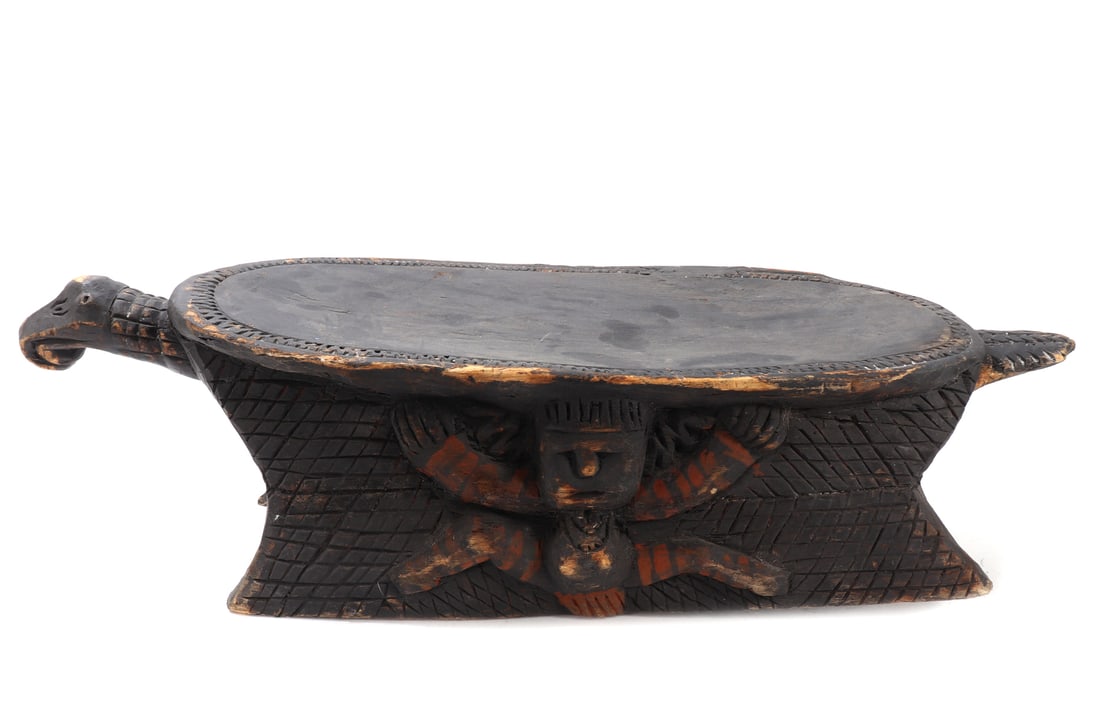 Papua New Guinea Turtle Stool, Kupkain Village, Upper Sepik: Papua New Guinea, Upper Sepik, Kupkain Village. Carved wooden stool in the form of a turtle, the oval seat raised on four tapering legs with the head projecting at one end and the shell suggested