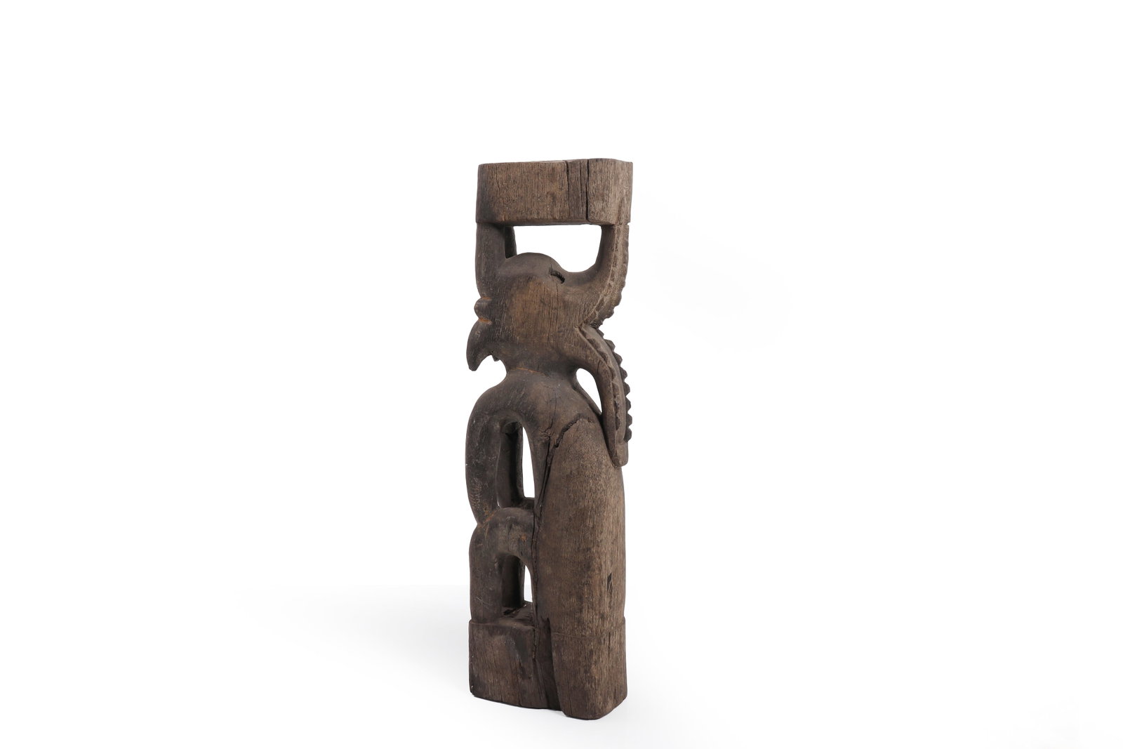 Borneo (Kalimantan), Dayak Carved Wooden Figure: Borneo (Kalimantan), Dayak Peoples 20th Century A carved wooden standing figure of elongated, attenuated form, depicted in a vertical composition with arms bent and held close to the body. The figure 