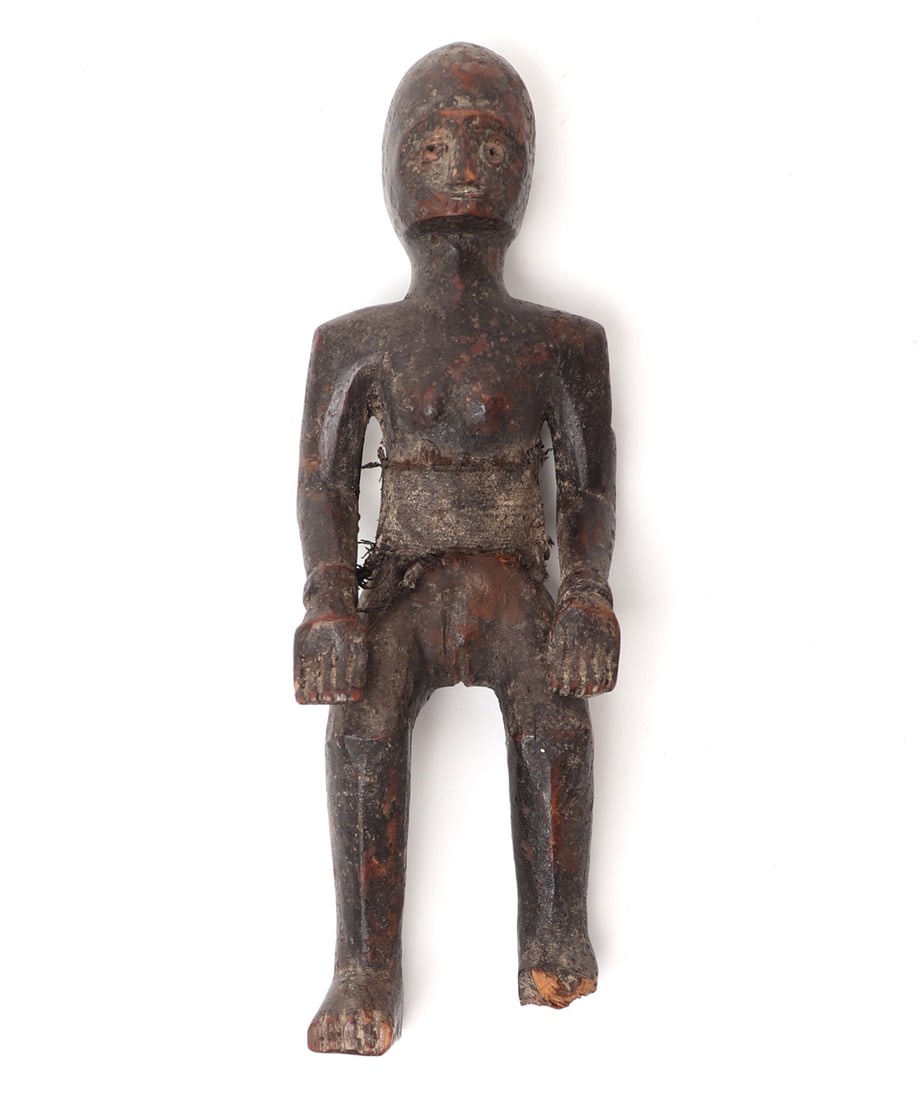 Southeast Asian Carved Wood Female Figure: Southeast Asia, probably 19th to early 20th century. Small carved wood female figure with a dark, time-worn surface and areas of reddish-brown exposed wood beneath the patina. The figure is shown in