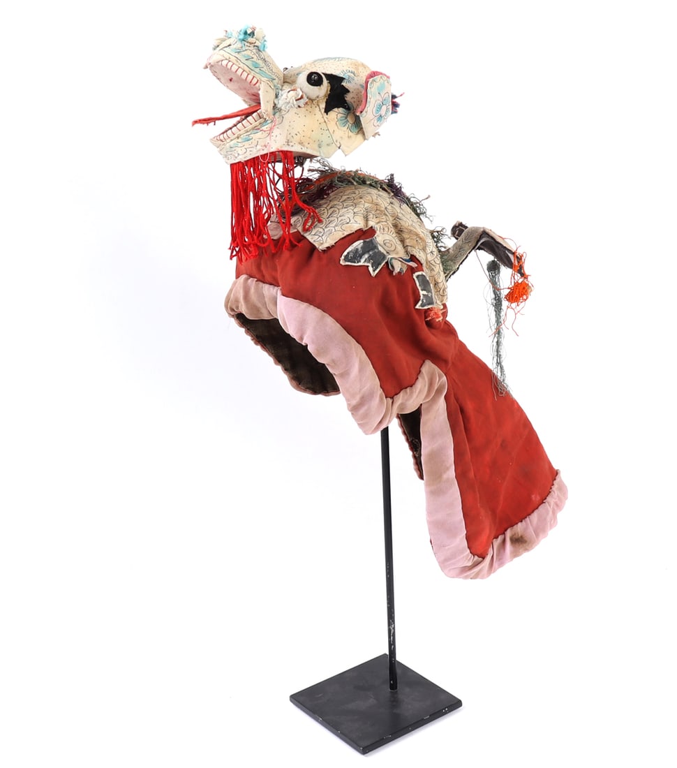 Colorful Jala Dance Dragon Headdress: Southeast Asia, 20th century. Colorful dance headdress in the form of a fantastical dragon or animal head, with painted features, open jaws, applied textile body, and trailing decorative elements.