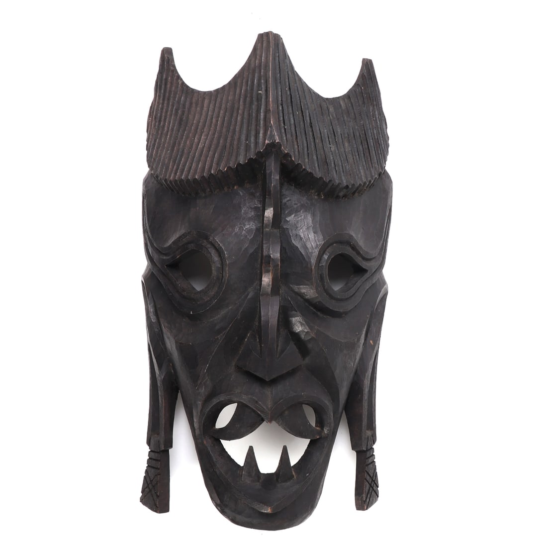 Nepalese Jakhri Folk Art Mask: Identified as a Nepalese Jakhri or shamanic folk art mask, likely late 20th century. Carved from dark stained wood in a dramatic animal or demon form, with pierced eyes and mouth, raised snout,