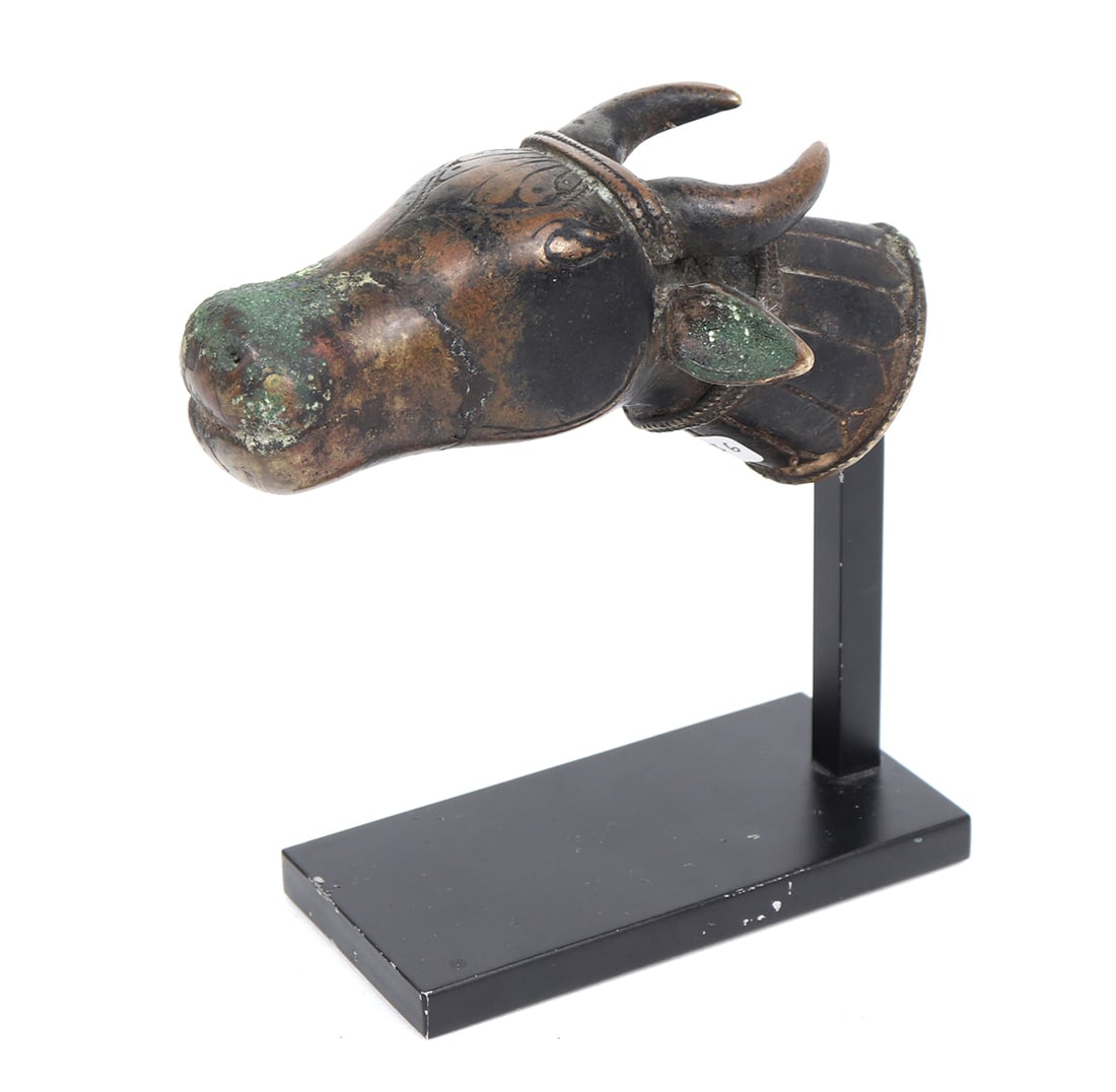 Bronze Finial in Form of Sacred Bull, Iranian 300 - 900CE: A finely cast bronze finial modeled in the form of a sacred bull, rendered with compact strength and dignified composure. The animal?s head projects forward with gently swelling muzzle and small