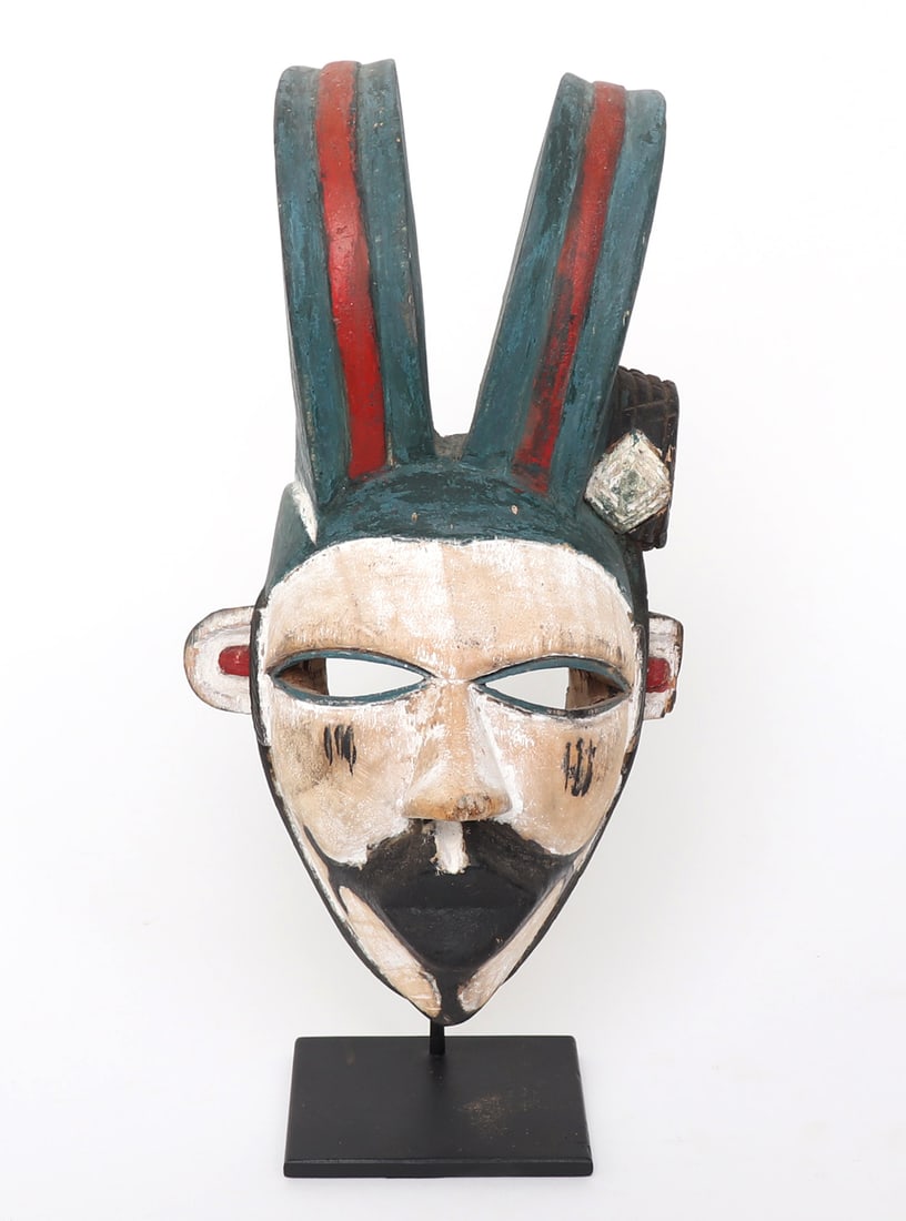Fine African Wood Carved Mask, Nigeria, 20th c.: Ogoni, Nigeria mid-20th C. Polychrome painted African wood carved mask. White face with black painted mouth, protruding arches horns painted turquoise and red. Open almond shaped eyes, and small