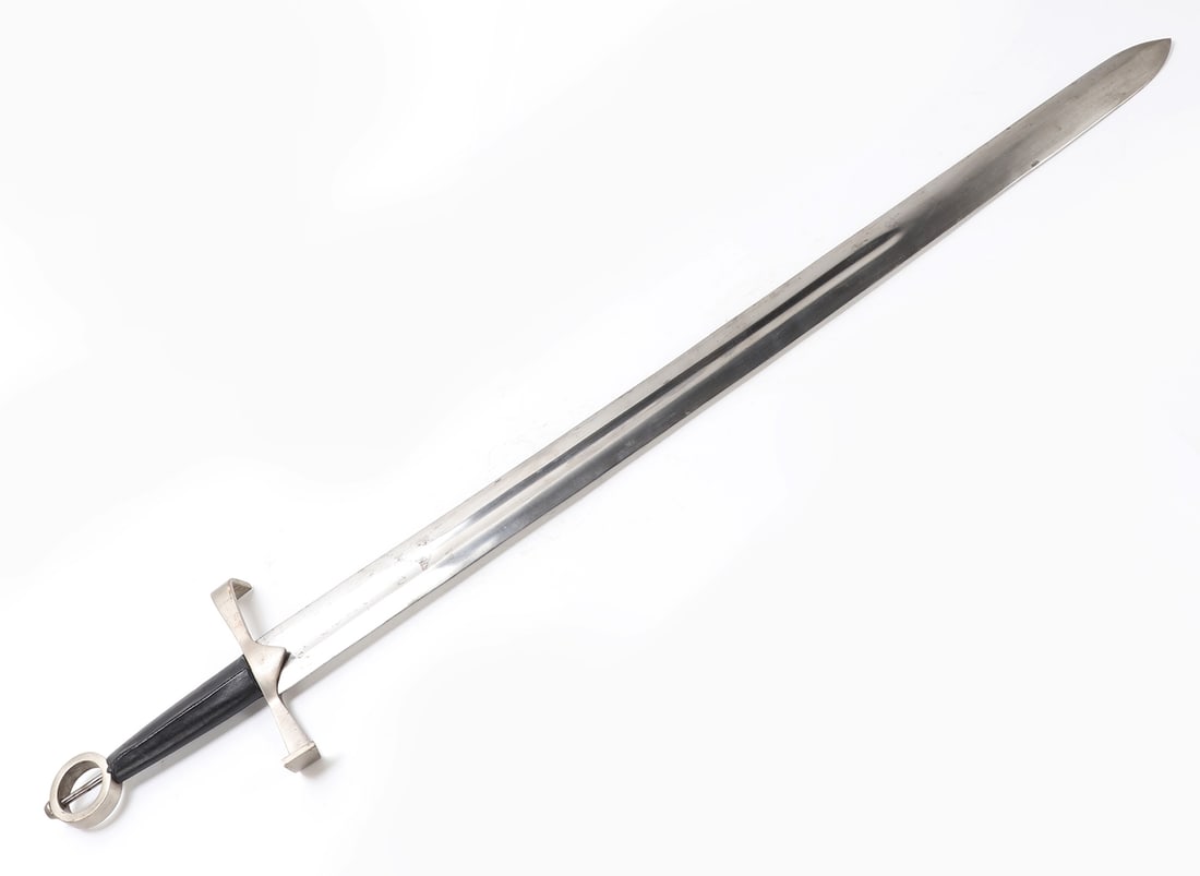Modern Decorative European Form Sword: Modern. Decorative sword with a double edged blade, long central fuller, straight crossguard, black grip, and circular ring pommel. The polished blade has a rounded spear point and appears made for