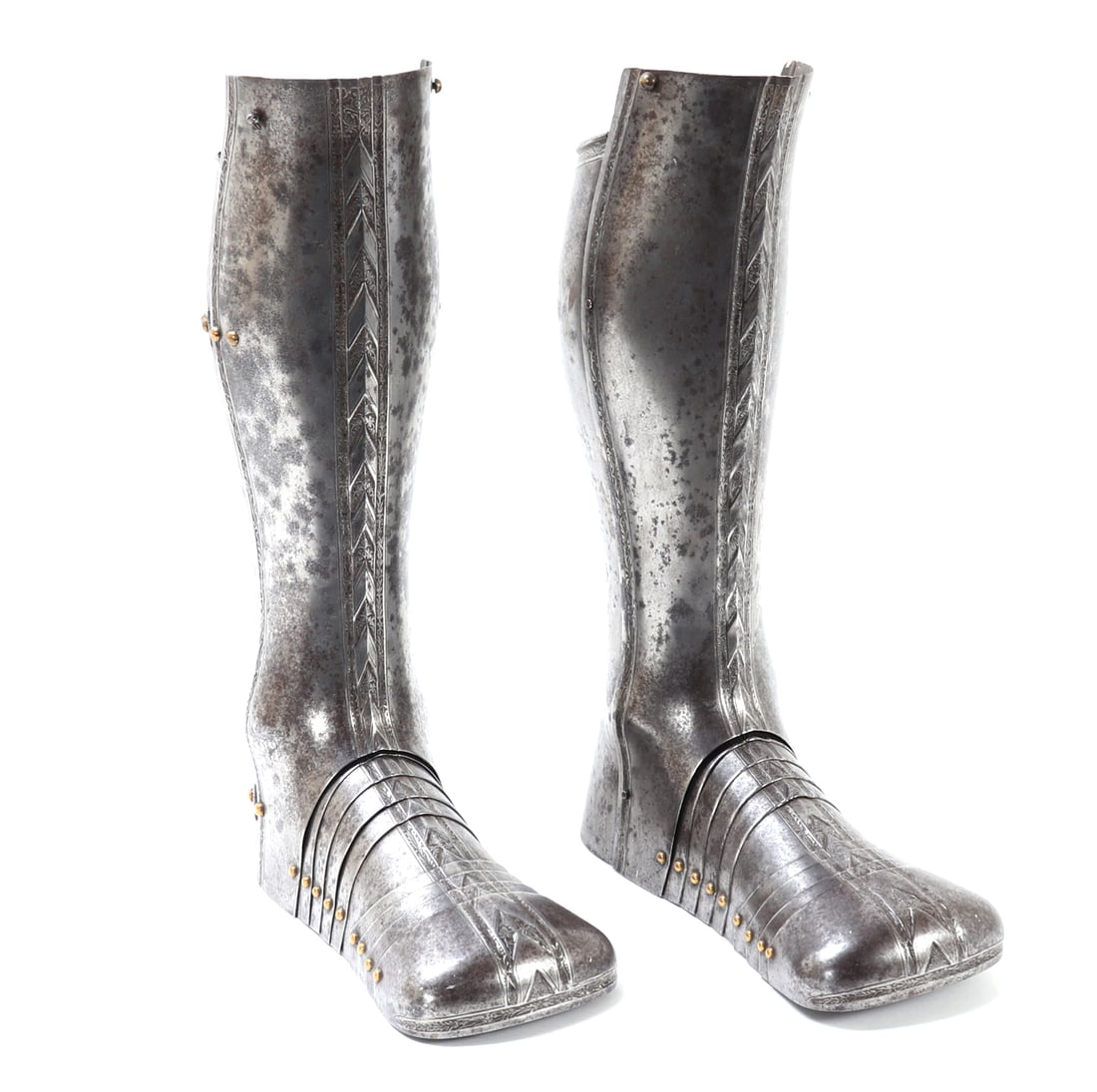 Magnificent Set of Etched & Embossed Legs: Matched pair of magnificent European greaves and sabatons with etched and embossed panels of chevrons between decoration and borders etched in steel. The sabatons with fantastic articulation and