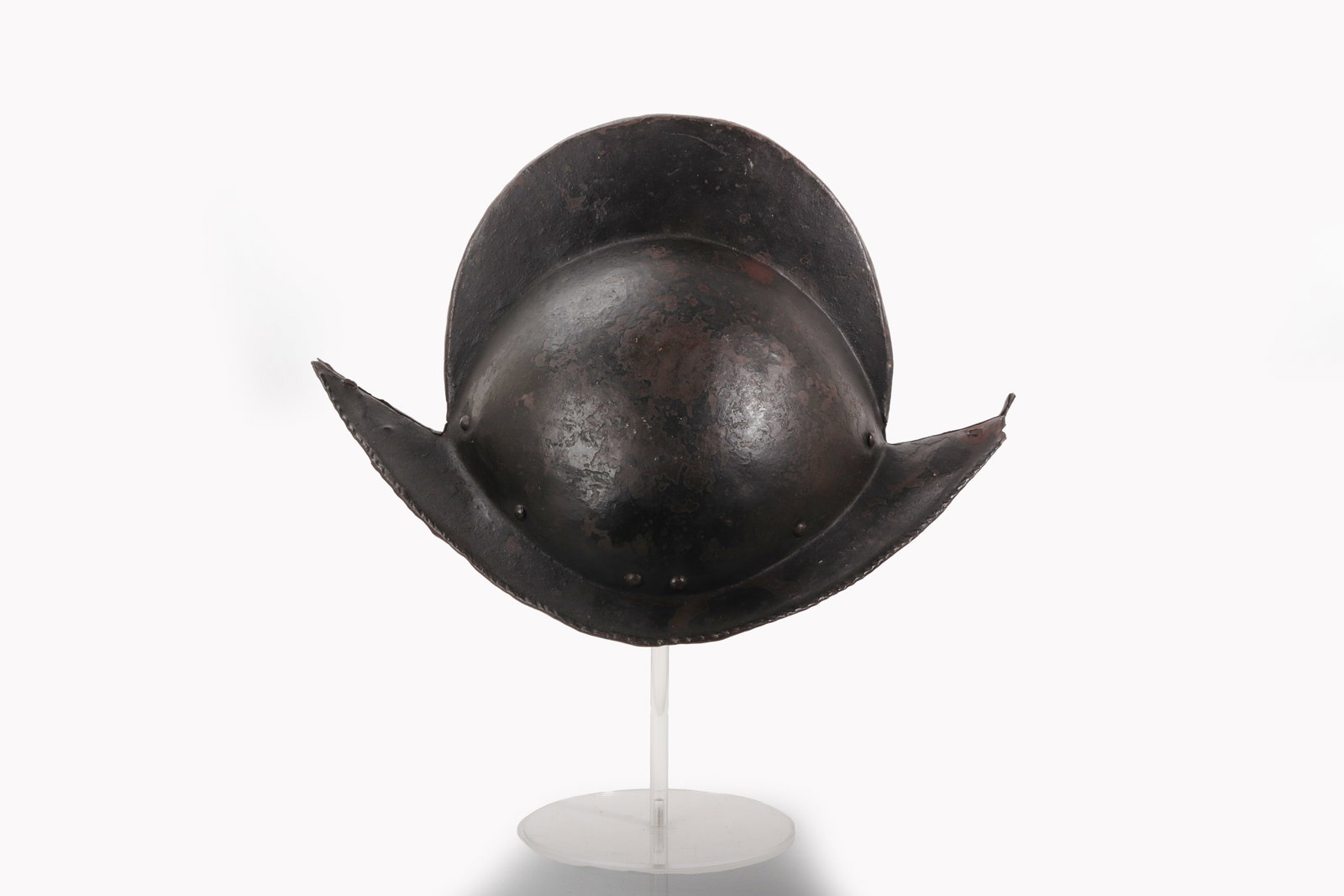 Spanish Comb Morion Helmet, 17th C.: Spain, 17th century. An iron comb morion helmet with rounded hemispherical skull, raised central comb, and broad swept brim rising to pointed terminals at the front, back, and sides. The helmet is