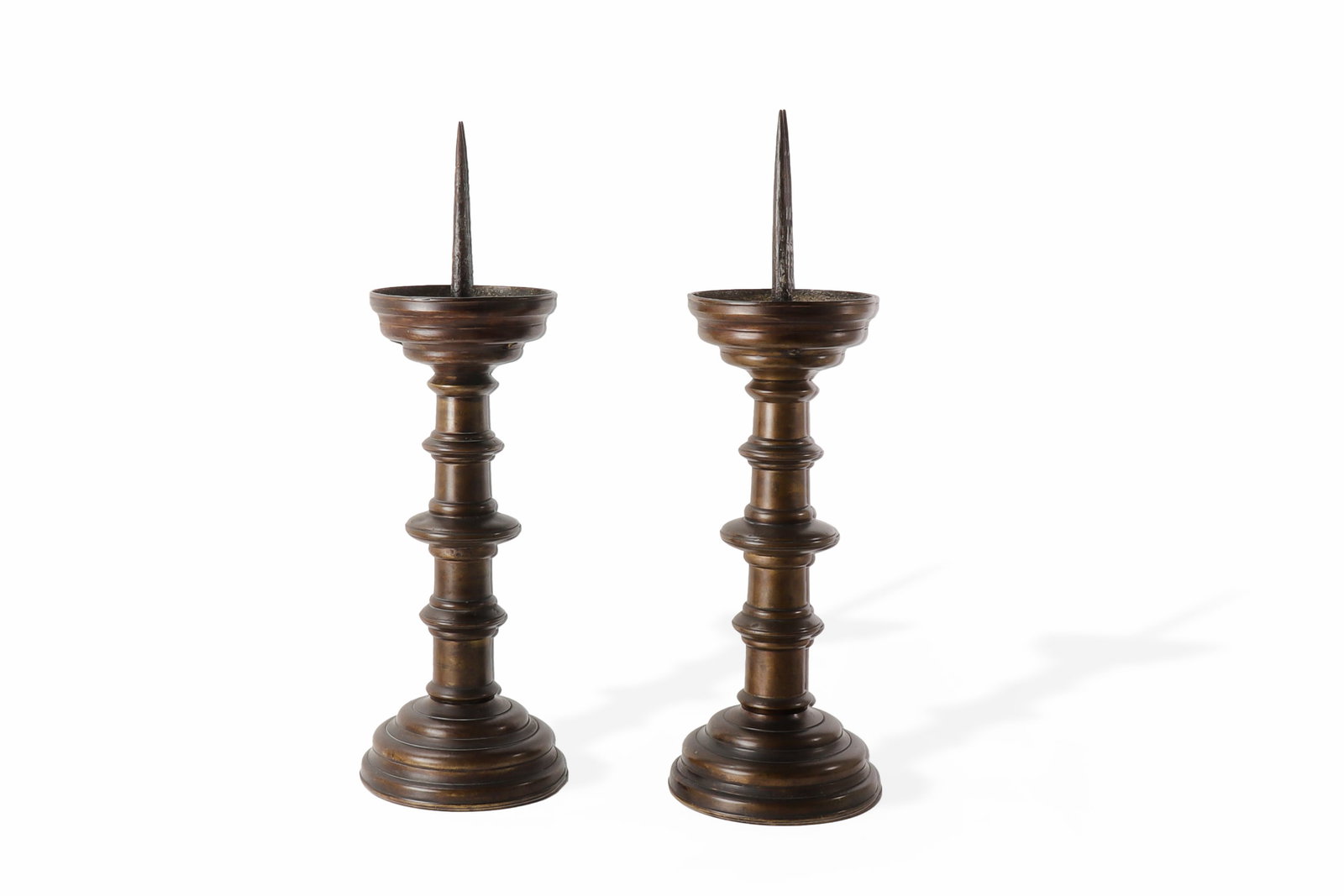 Pair of Gothic Brass Pricket Candlesticks, circa. 1460-1480: German stamped Nuremberg type, late Gothic to early Renaissance period, 15th century, circa 1460-1480. Pair of brass pricket candlesticks, each with broad circular base, turned and ringed shaft, and