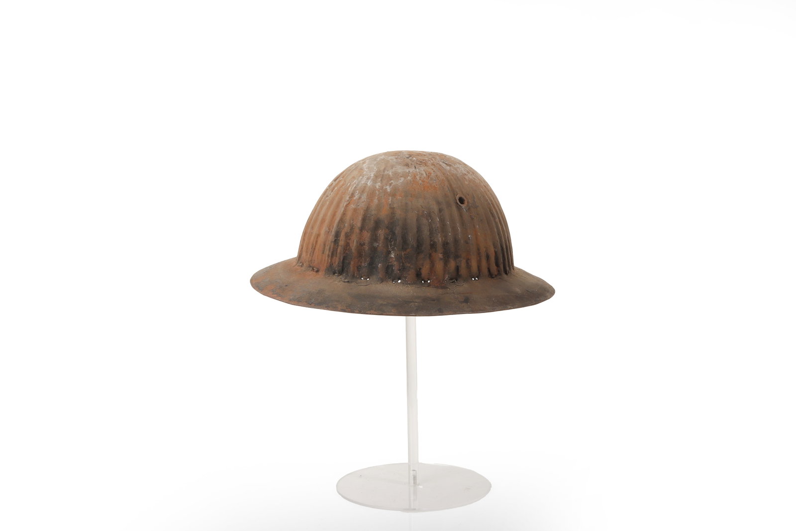 Portuguese Model 1916 Steel Helmet: Portuguese, First World War period, circa 1916. A Model 1916 steel helmet of shallow circular form with broad brim and distinctive ribbed crown. The helmet has ventilation holes around the lower