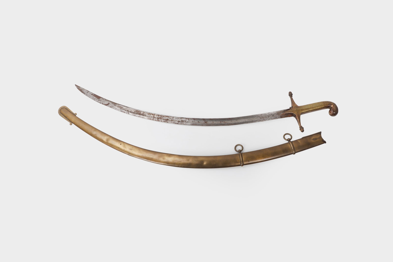 Mameluke Type Officer?s Saber with Scabbard, 19th C.: A 19th century Mameluke type officer?s saber, the curved single edged steel blade formed with a raised back edge near the tip and showing age patina throughout. The brass hilt has a crossguard with
