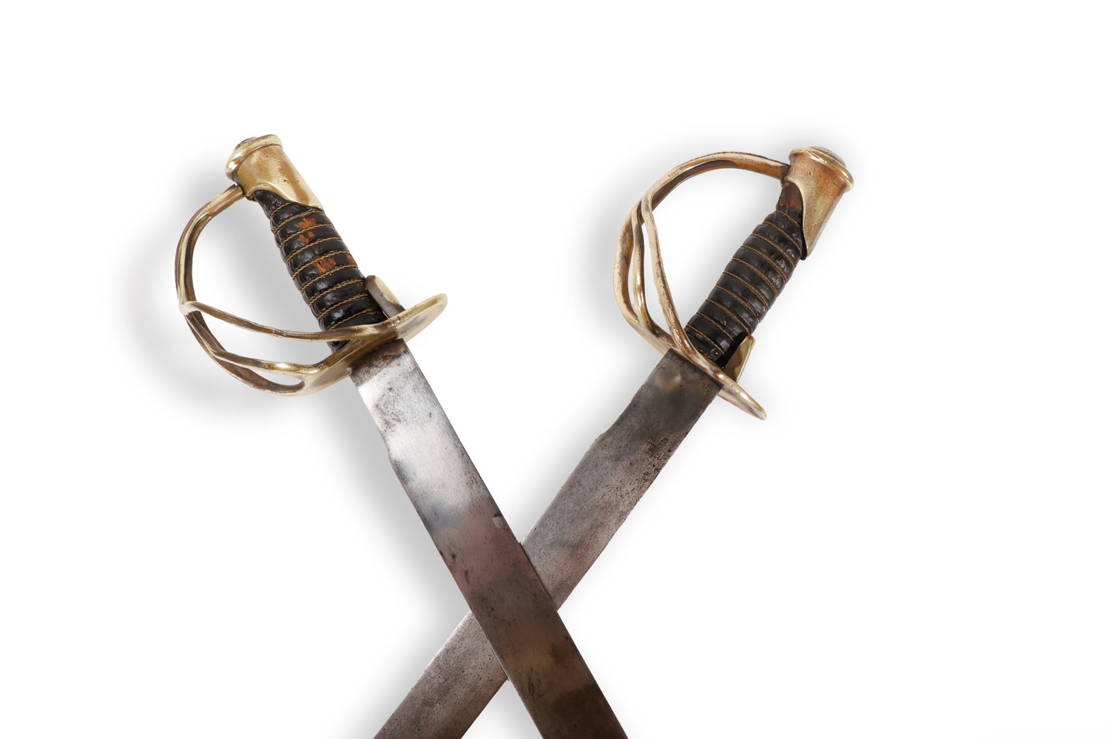 French Cuirass Model 1822 Sword Set, 19th C.: France, 19th century. Pair of French Model 1822 style cavalry swords with curved single edge fullered blades, brass guards, brass pommels, and dark leather wrapped grips. Each sword has a rounded