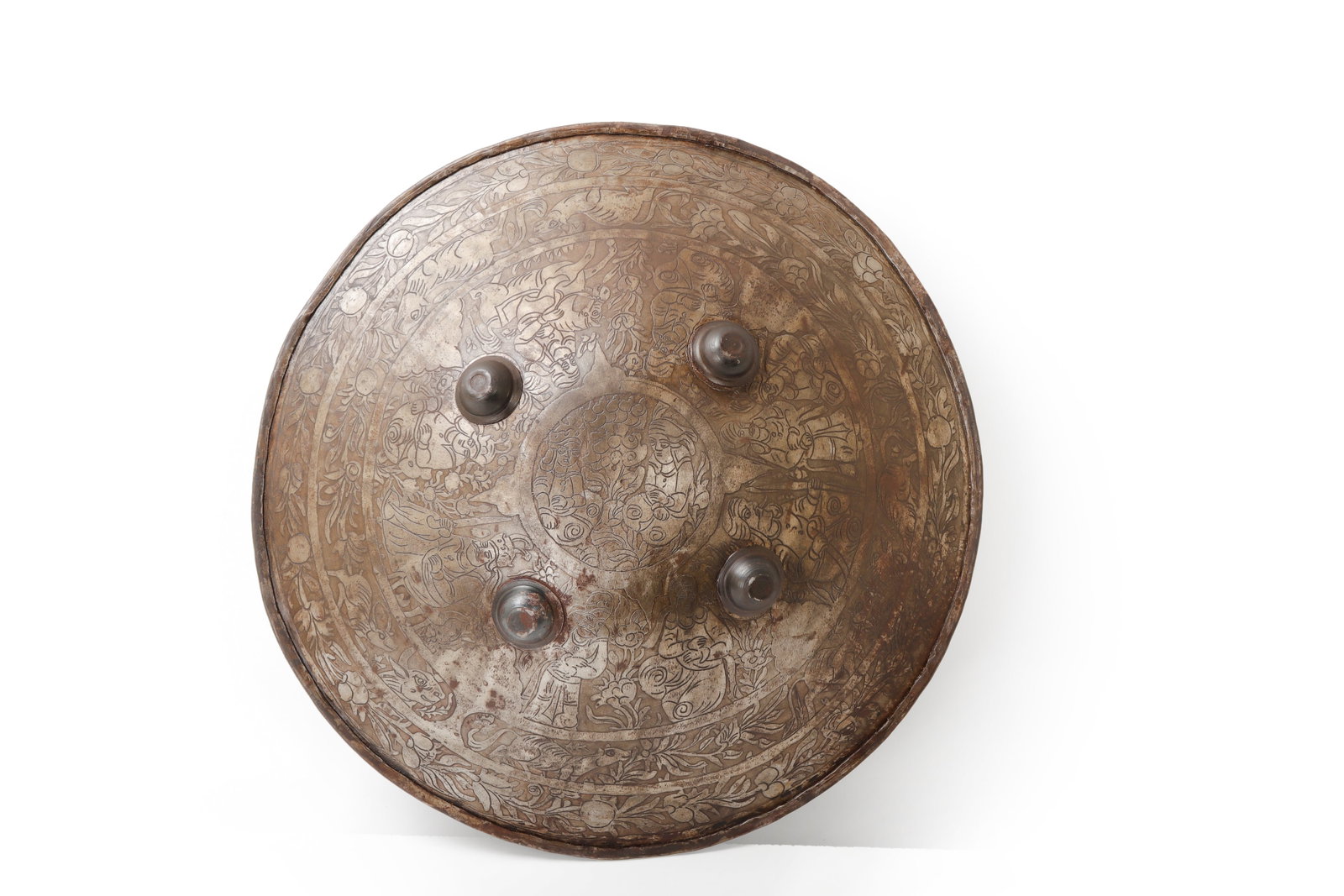 Persian Etched Steel Shield, Late 19th - Early 20th: Persia, late 19th or early 20th century. Circular steel shield with four raised bosses, a rolled outer rim, and dense acid etched decoration across the face. The etched design includes floral